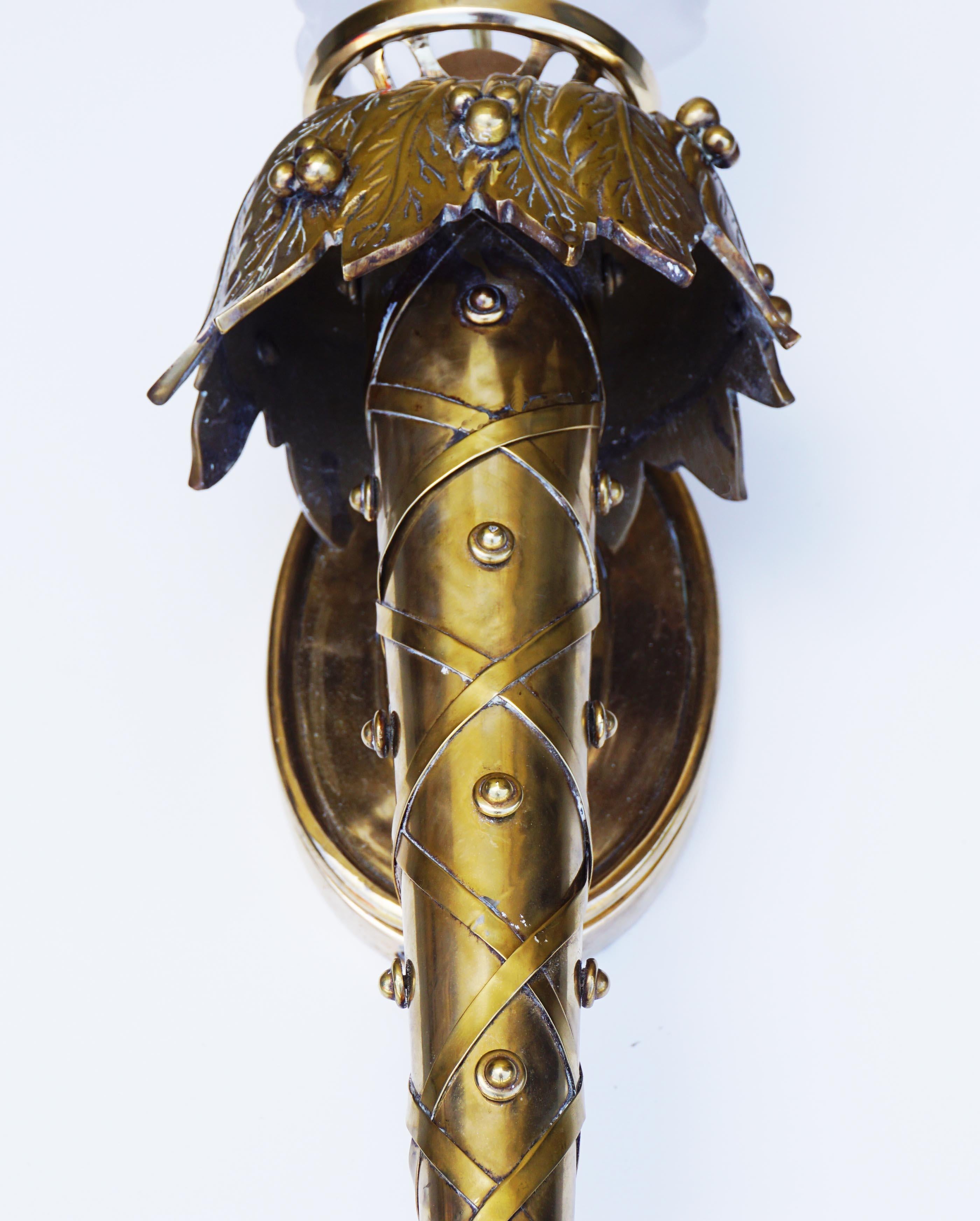 Beautiful and substantial studded bronze/brass torchère wall sconces will make a dramatic statement in any room. Created by Chapman Manufacturing, circa 1990s. Condition: Good; Fully restored; newly polished with new glass flame fitters for extra