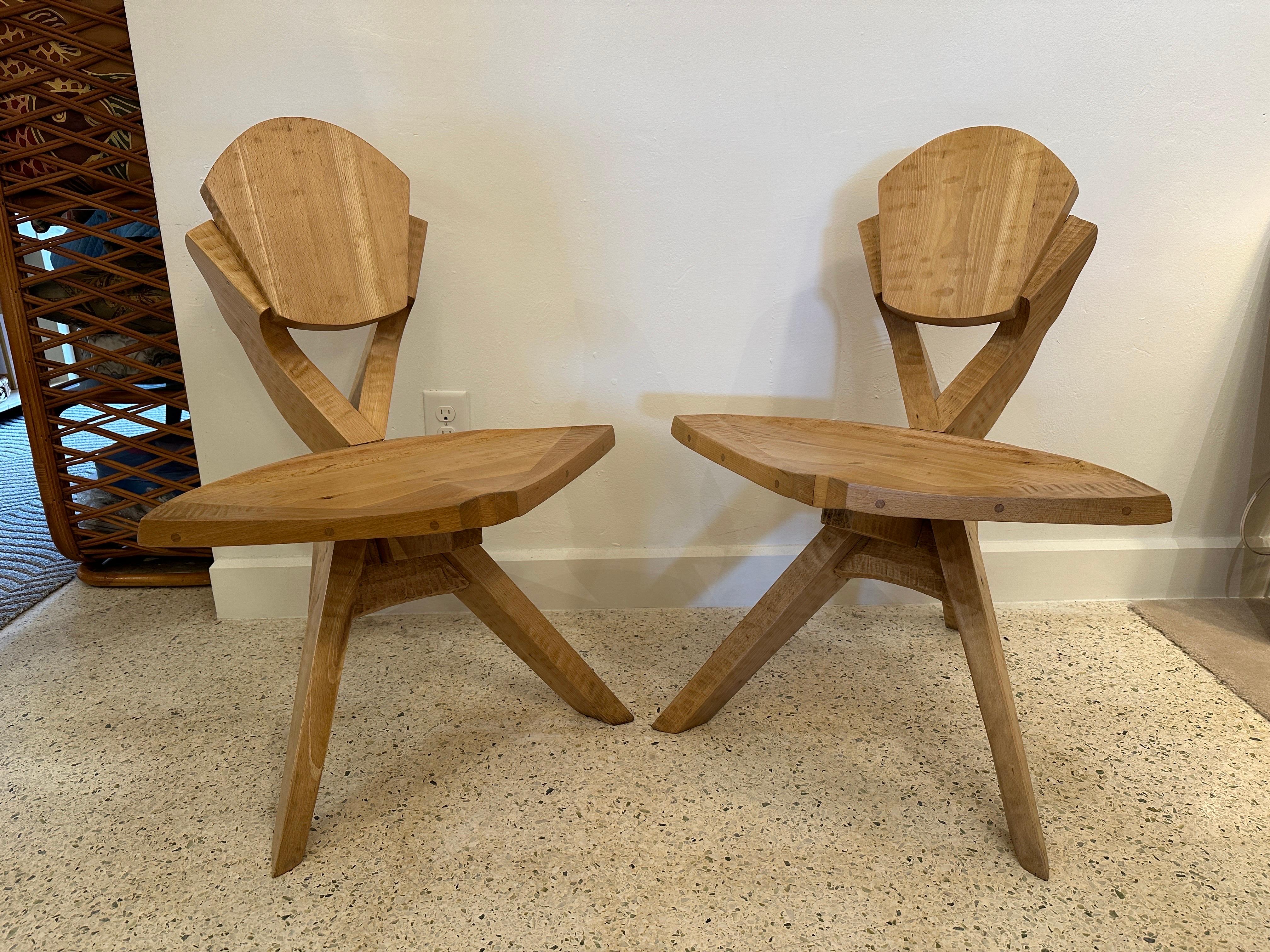 This pair of hand crafted sculptural wood chairs feature 3 legs and extraordinary details to back rest and seat - SEE detail images and video provided. Architecturally wonderful!  THIS ITEM IS LOCATED AND WILL SHIP FROM OUR MIAMI, FLORIDA