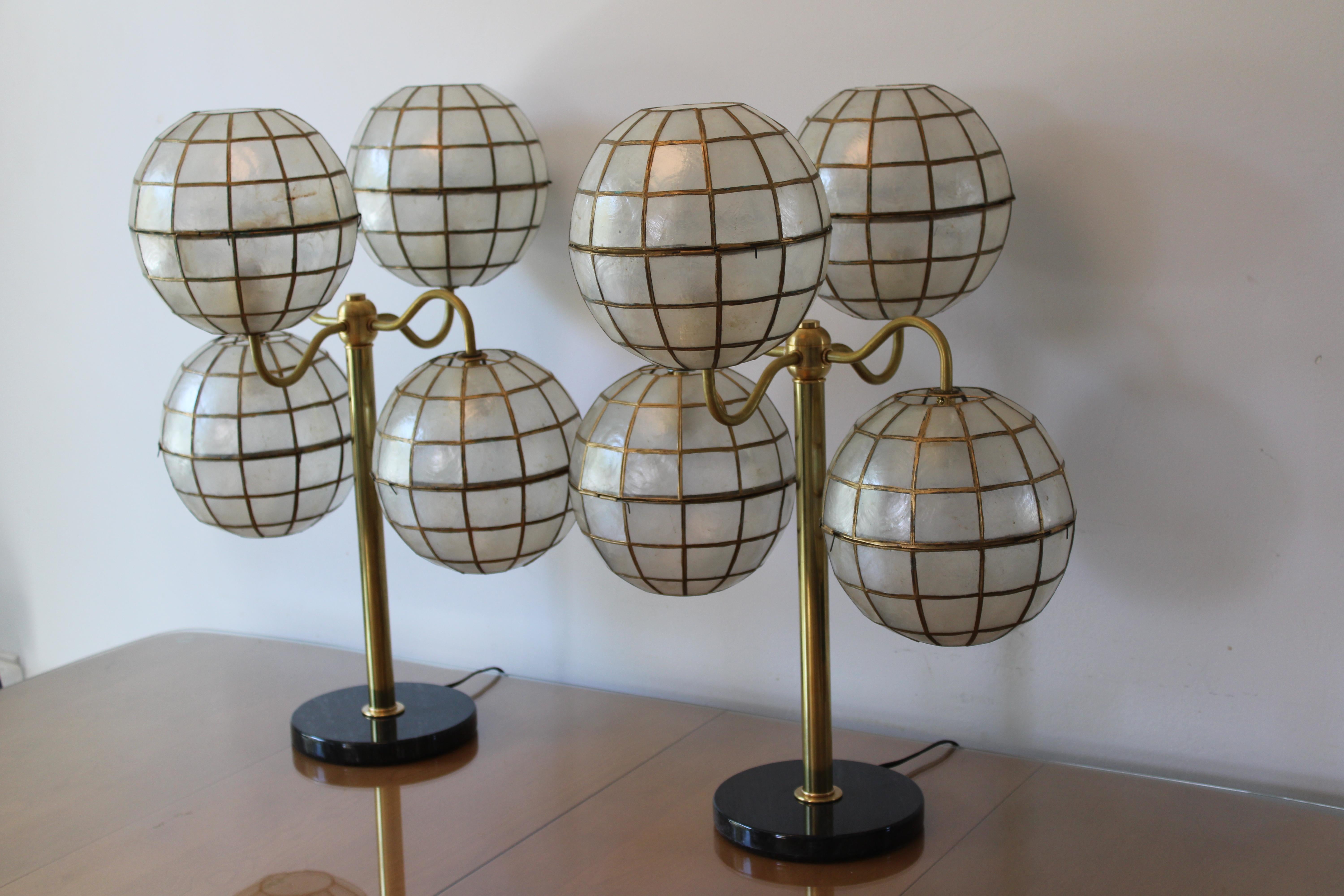 We took vintage capiz shell globes and made these wonderful lamps. All new brass hardware and marble bases. Newly rewired with an on/off switch. Each lamp measures 20” diameter and 24” high. Capiz globes are 8” diameter and 8.5” high. Marble base is