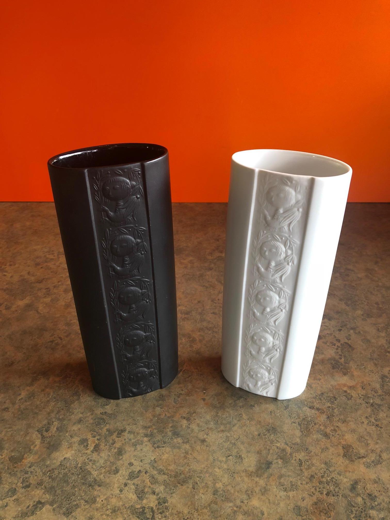 A pair of midcentury papagena vases by Danish artist-cum-designer Bjorn Wiinblad for Rosenthal of Germany as part of their extensive artist-led Studio Line series, circa 1970s.  #547

The vases are white and black porcelain with a matte finish in