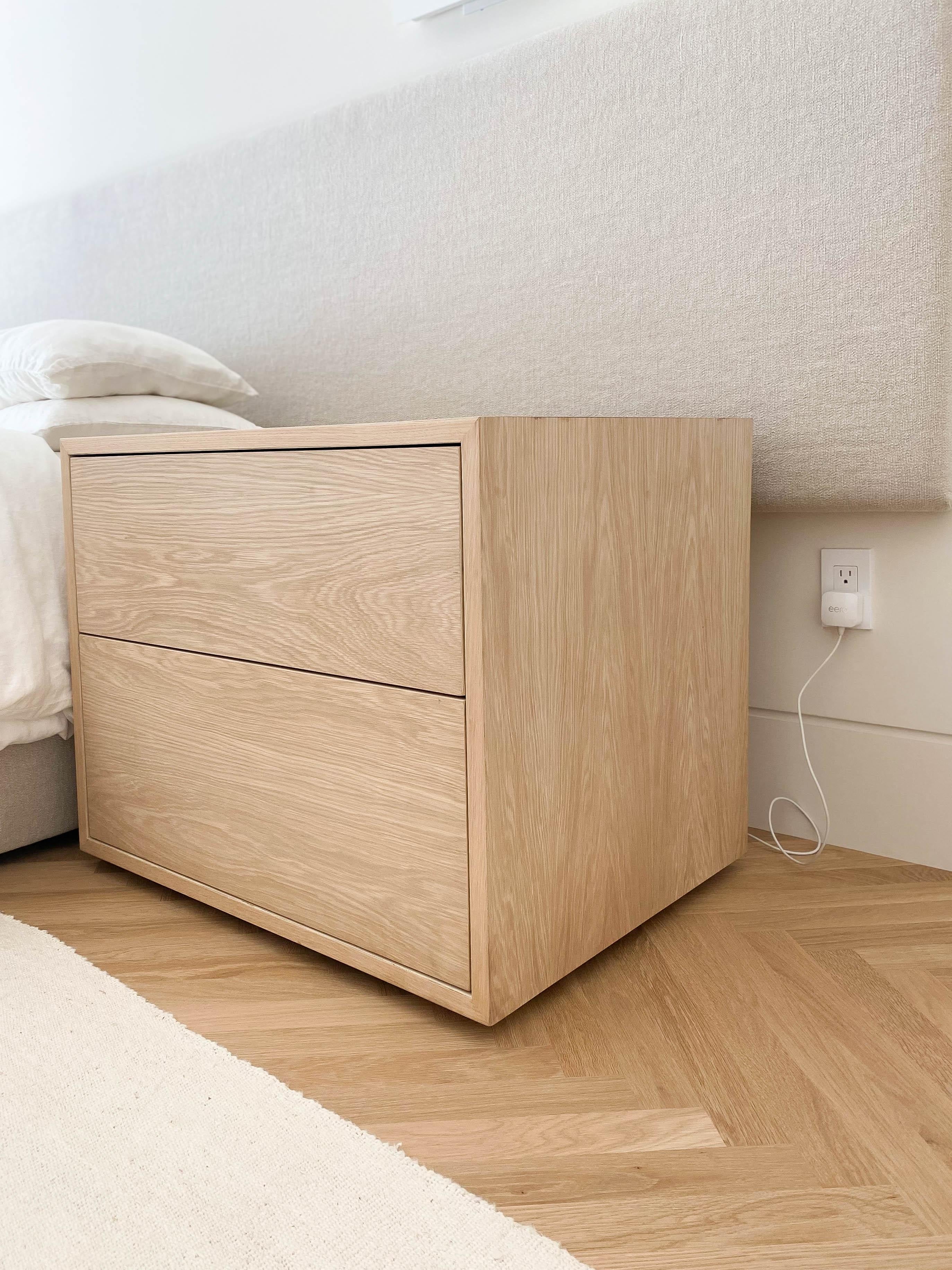 Pair of customizable Studio Osklo nightstands in raw bleached oak featuring deep, double drawers.