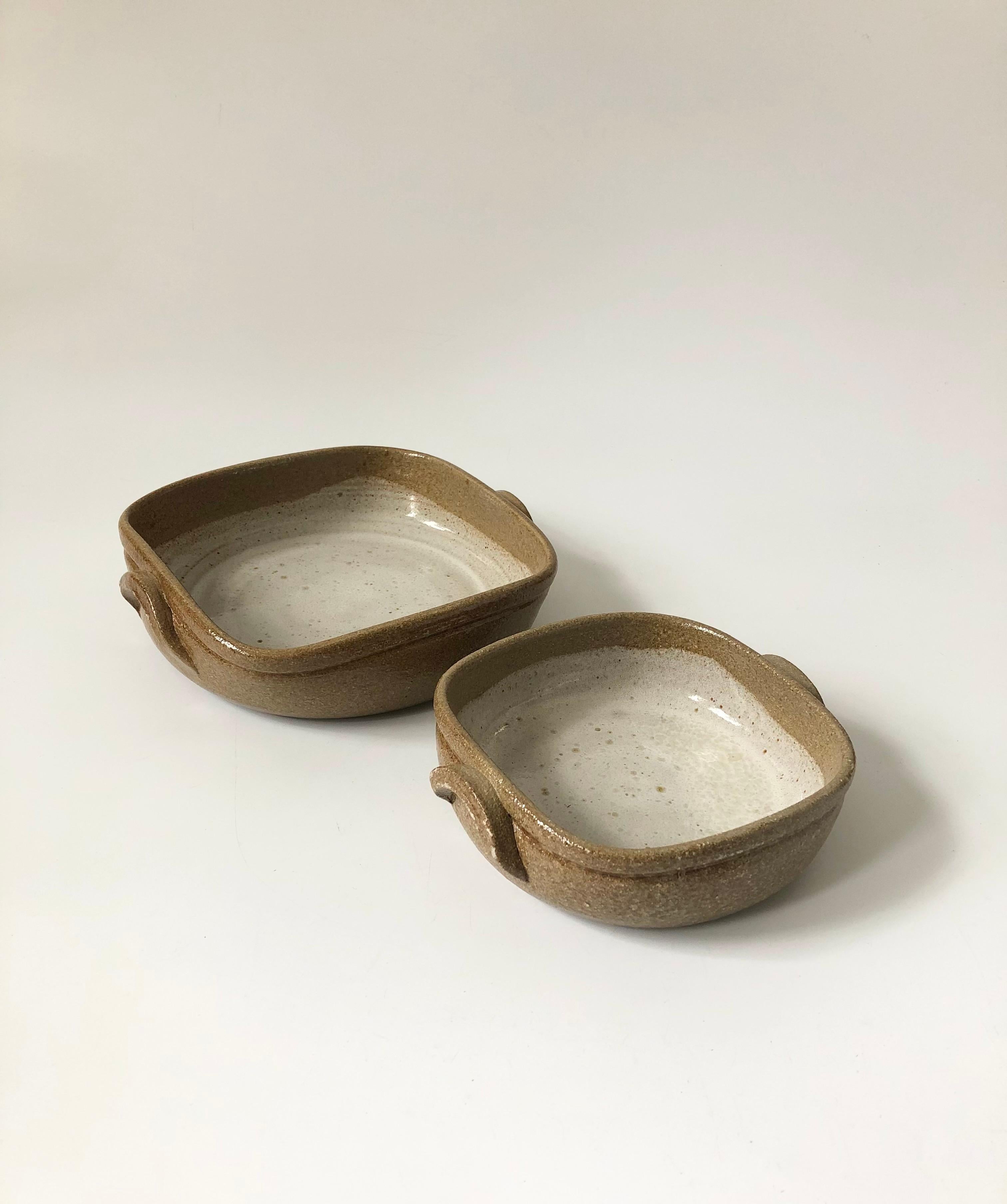 A pair of vintage Studio Pottery serving trays. Beautiful speckled earthy glazes and rounded square shapes, each with handles formed on the sides. Nest neatly into each other for storage. Made in Portugal.
The larger tray measures 7.25