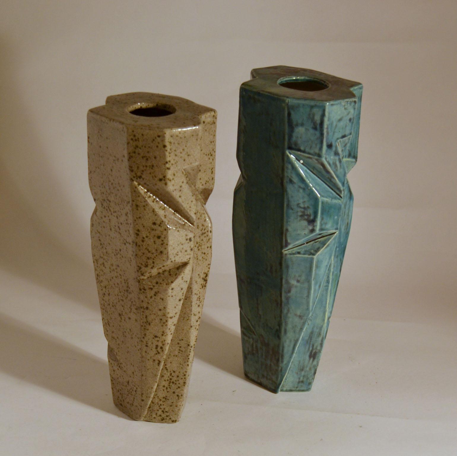 Hand formed elongated studio pottery vases in angular form with sharp incisions made in limited edition, signed by Dutch H. Naus.
Each vase is slightly different and in different glaze and height.
Blue vase height 35.5 cm
Sand color vase height