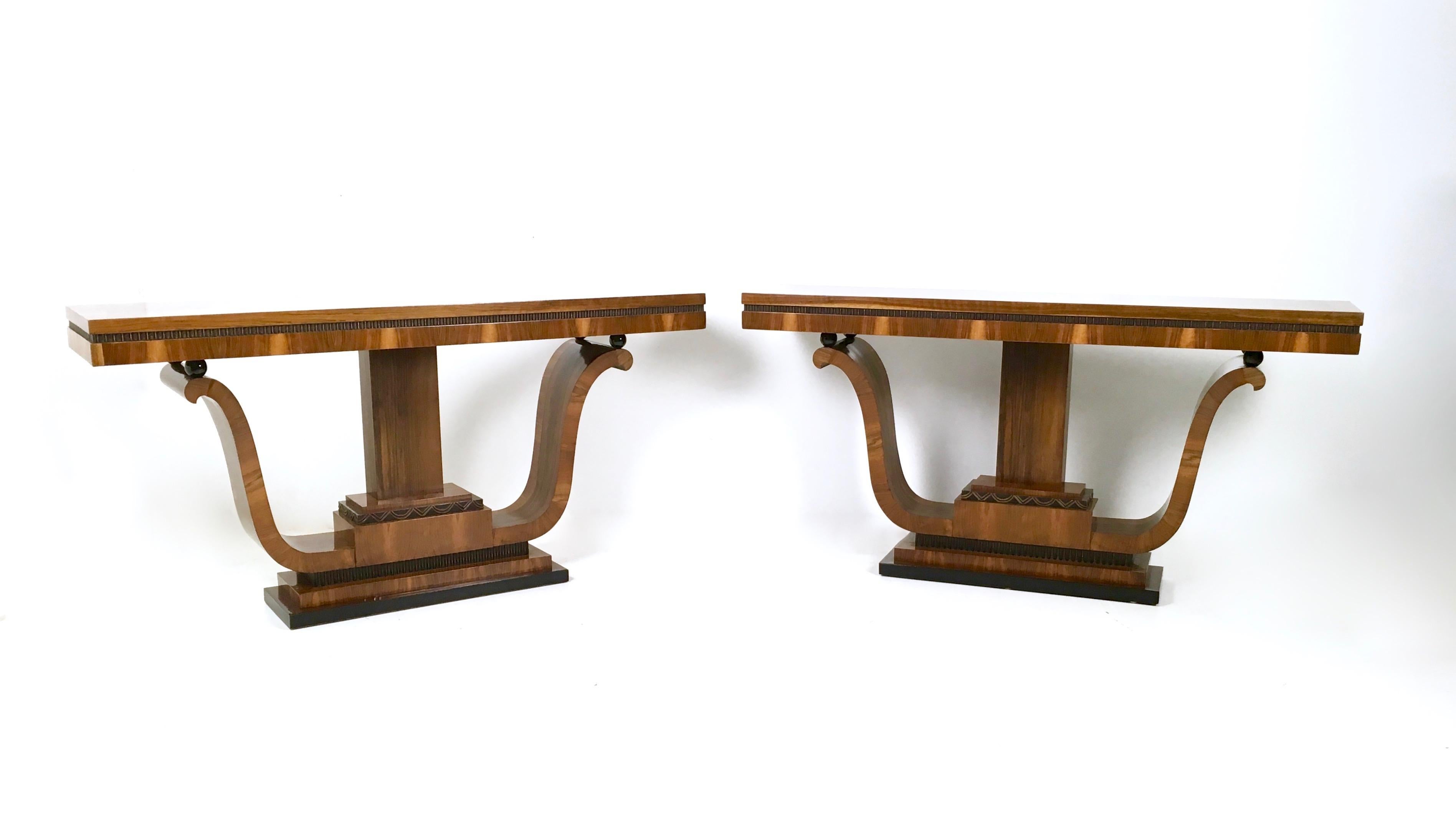 They are made in walnut and feature ebonized wood parts.
These two beautiful consoles have been perfectly restored and polished with shellac. 
They might show slight traces of use since they are vintage, but they can be considered as in perfect