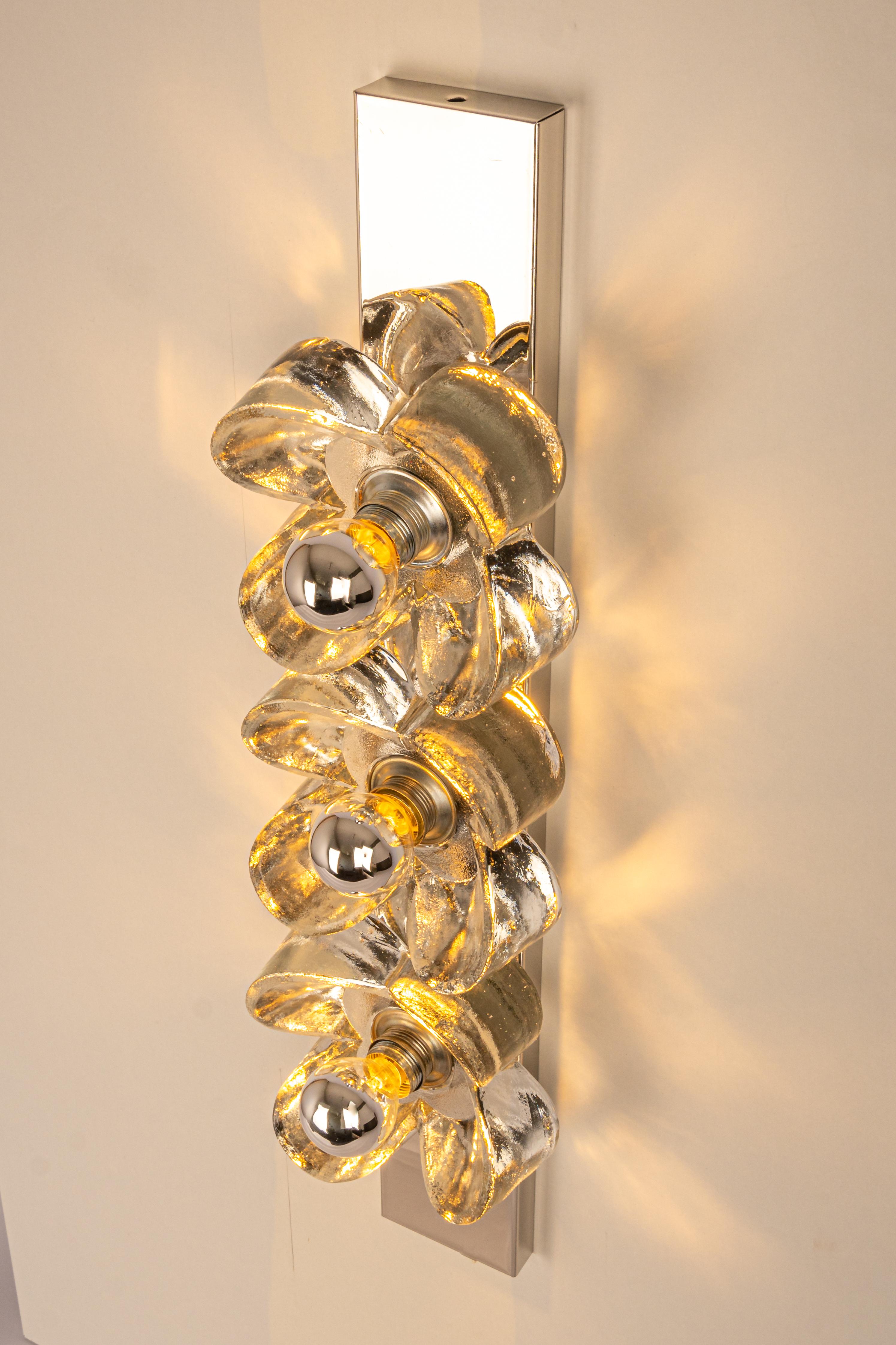 Fantastic mid-century wall light by Sische, Germany, manufactured, circa 1970-1979. 
3 Murano glass pieces mounted on a chrome frame.
High quality and in very good condition. Cleaned, well-wired, and ready to use. 

The fixture requires 3 small