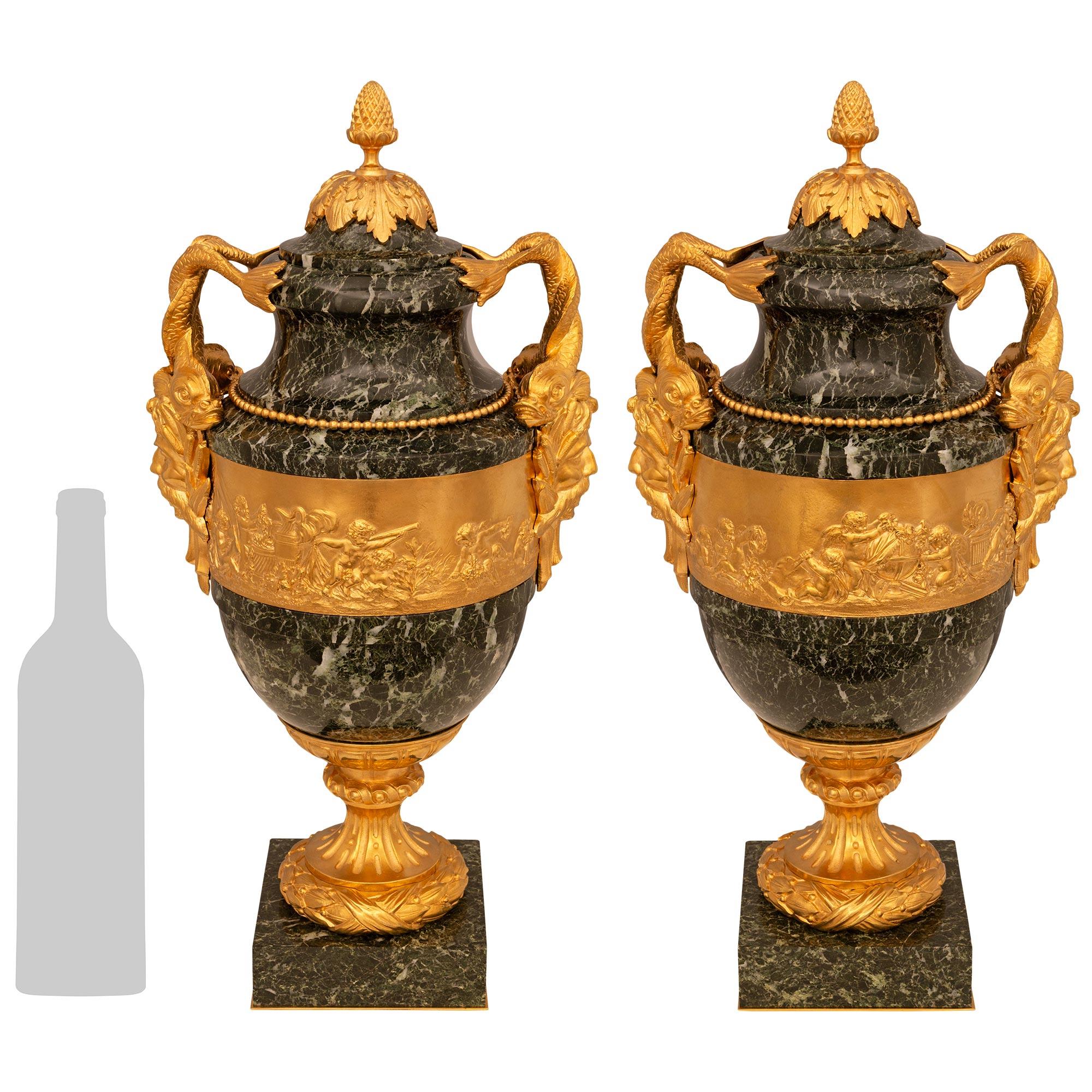 A stunning and high quality pair of French 19th century Louis XVI st. Vert Patricia marble and Ormolu lidded urns. Each urn is raised on a square marble base with a foliate Ormolu socle pedestal above a wrap around laurel band. Each of the Verte