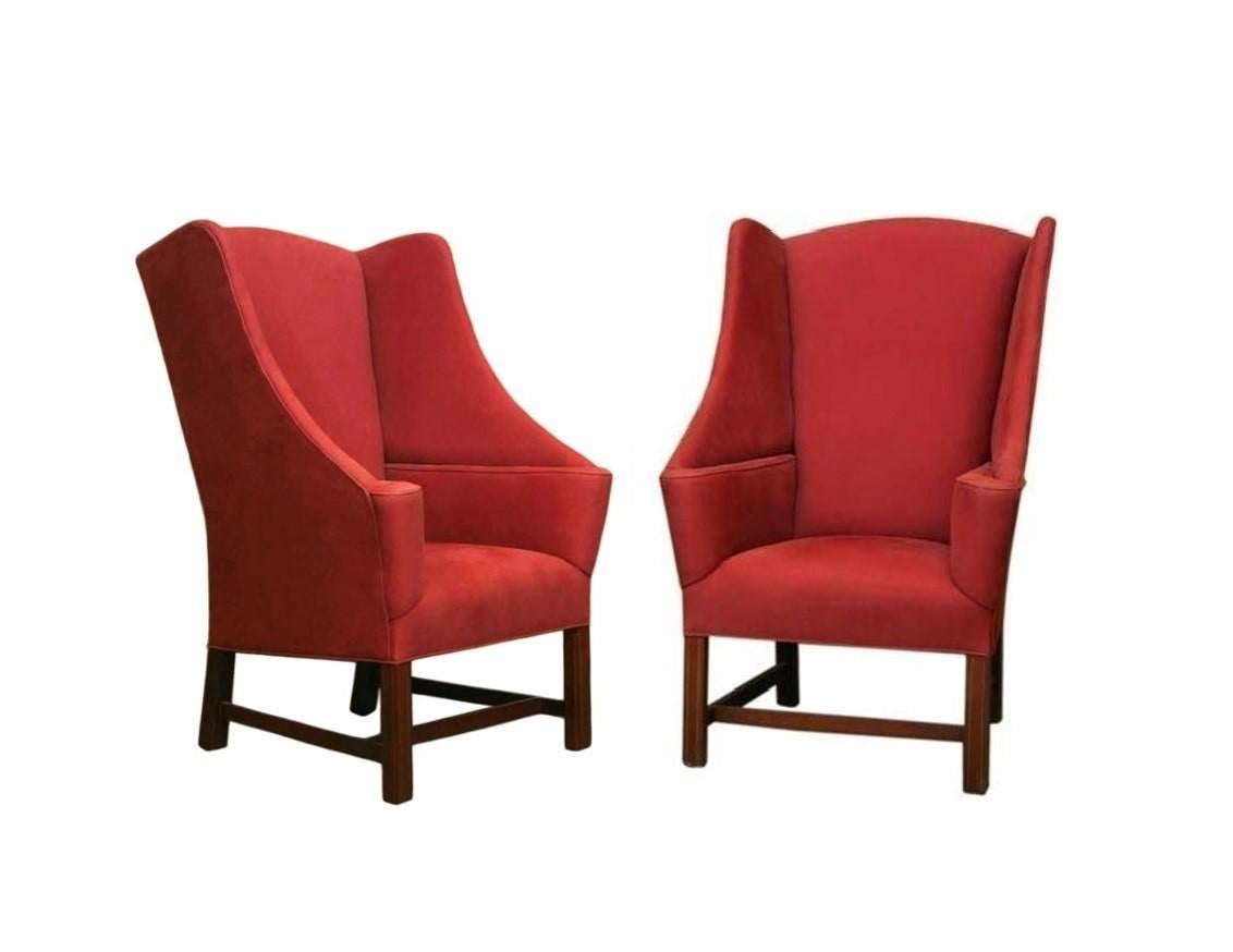 Whether you are ready to read a good book or smoke a cigar, each chair invites one to sit back, relax and reflect. Offered is a pair of handsome wingback library chairs made in the English Georgian taste. Constructed from hardwood frames