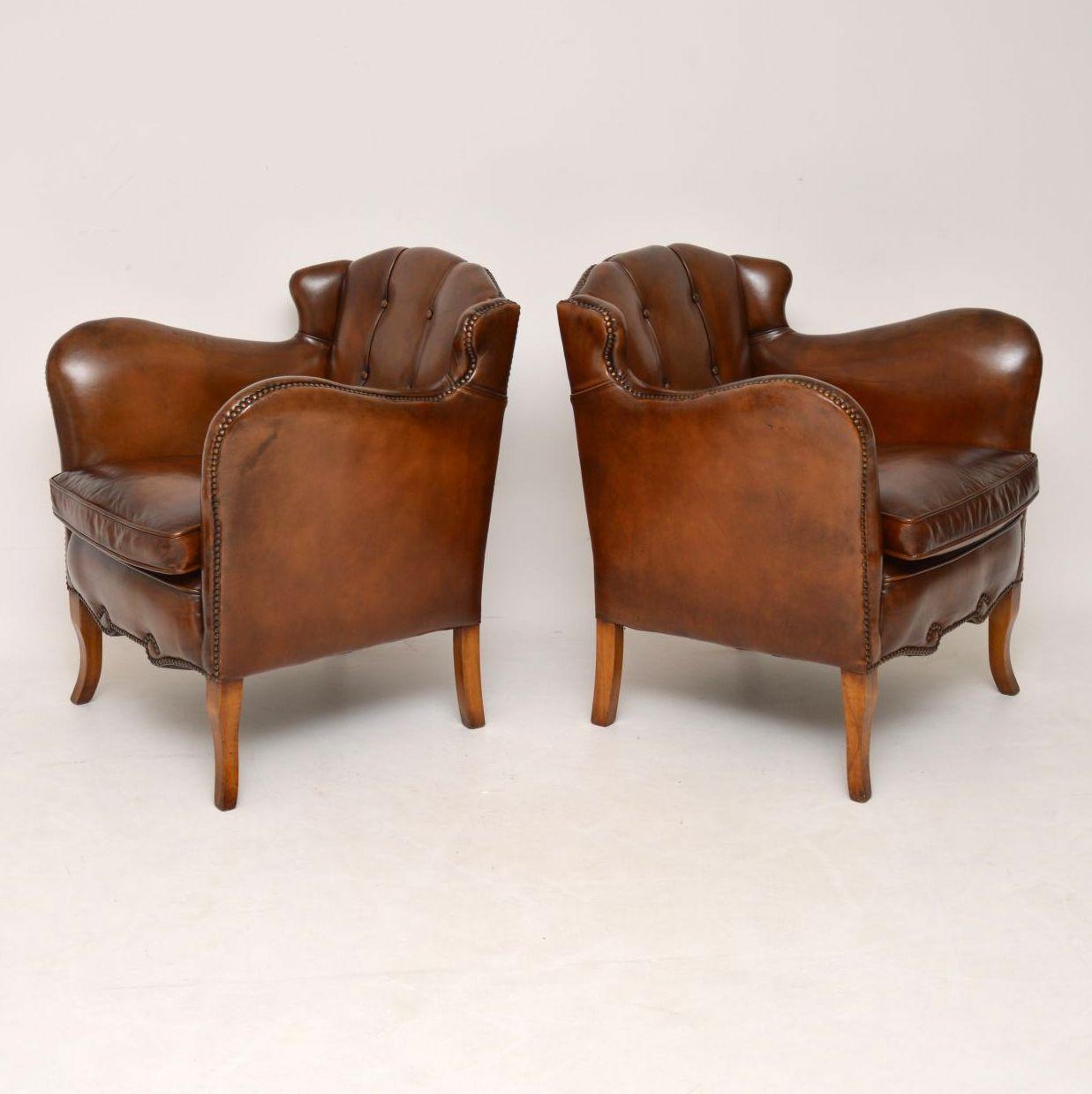 Very stylish pair of Swedish antique leather armchairs in fabulous condition and dating to circa 1890-1910 period. These chairs have wonderful shaping and features all the way around, so please enlarge all the images. The inside backs are deep