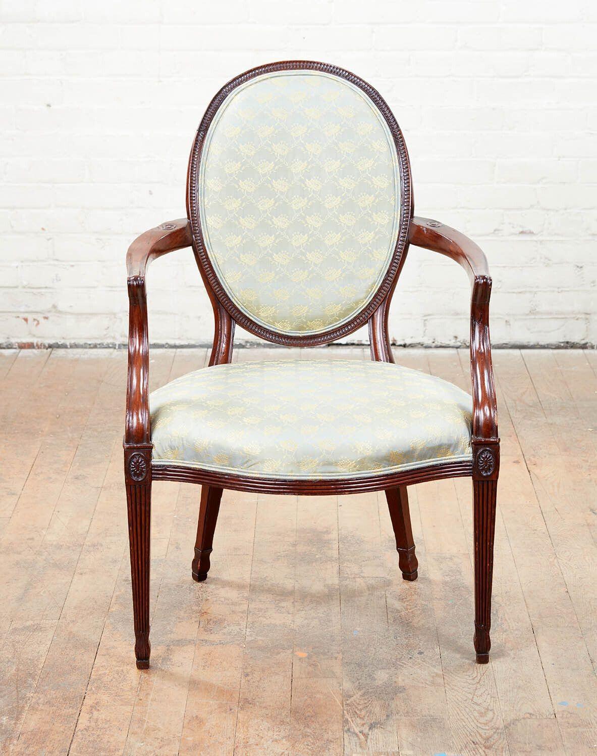 Fine pair of George III mahogany armchairs, the oval backs with fluted surrounds, the arms with scroll carved florish over shaped seats with ribbed rails, the patera carved tapered legs with fluting and long leave carved shaped feet.
 
seat height