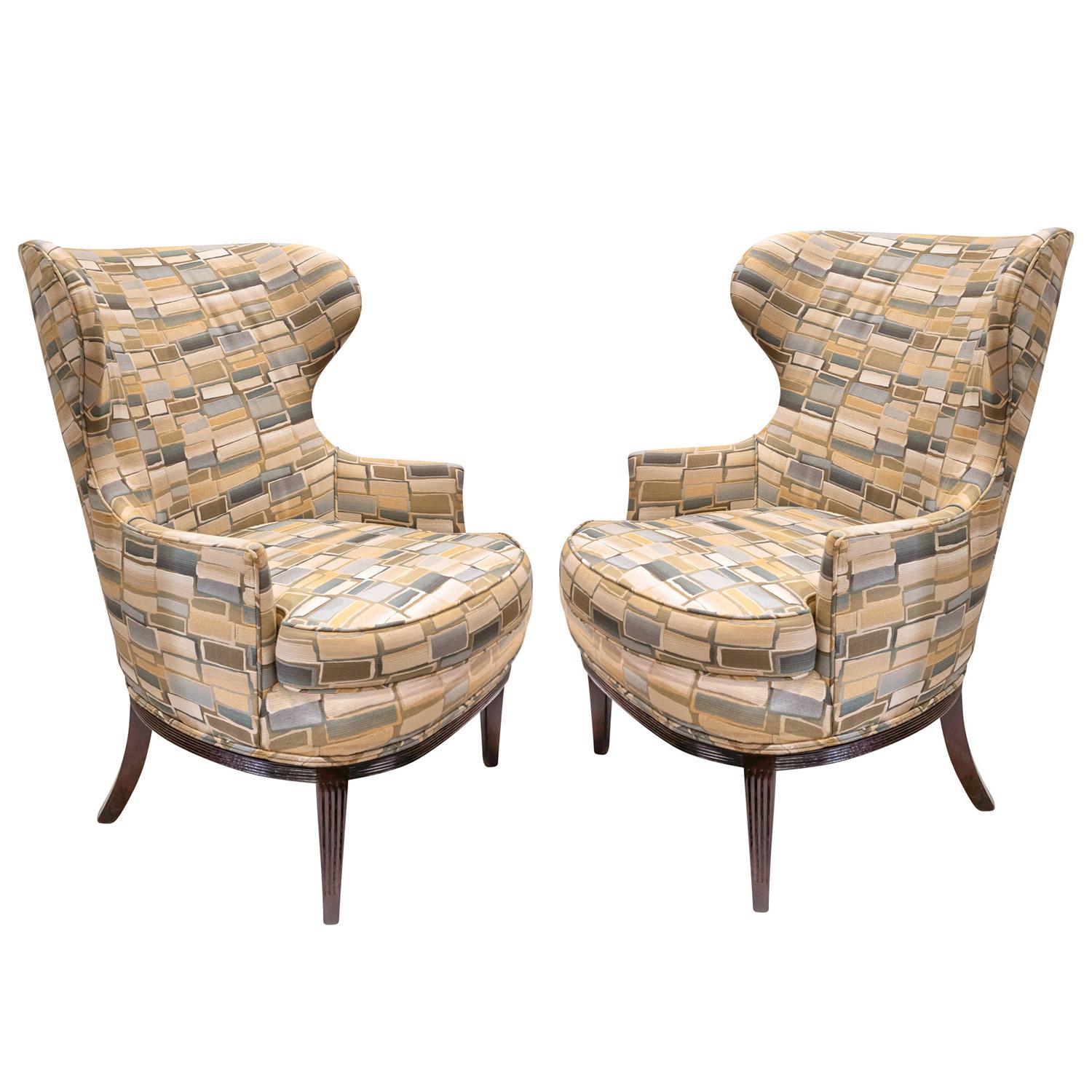 Pair of stylish wingback chairs with fluted wood bases in the style of Paolo Buffa, Italian 1950's.  These chairs are both beautiful and comfortable. Bases have been newly refinished.  These were recently reupholstered.