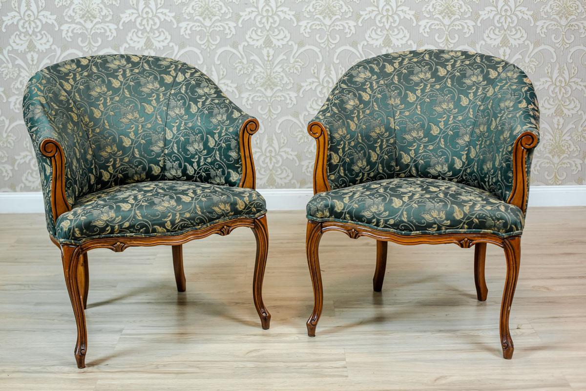Pair of Rococo Revival Stylized Armchairs From the 1970s-1980s

We present you two neat, wooden armchairs on bent legs.
The furniture has upholstered seats, and full and rounded backrests. The back rails are slightly shifted back.
The armchairs are