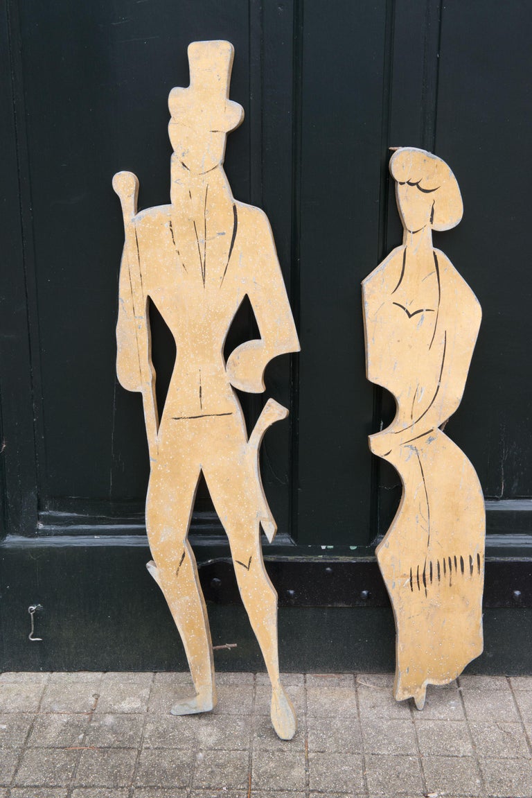 Pair of 1890s style figures of a man in a top hat with a walking stick and a svelte woman made of metal form France.
Woman is 9