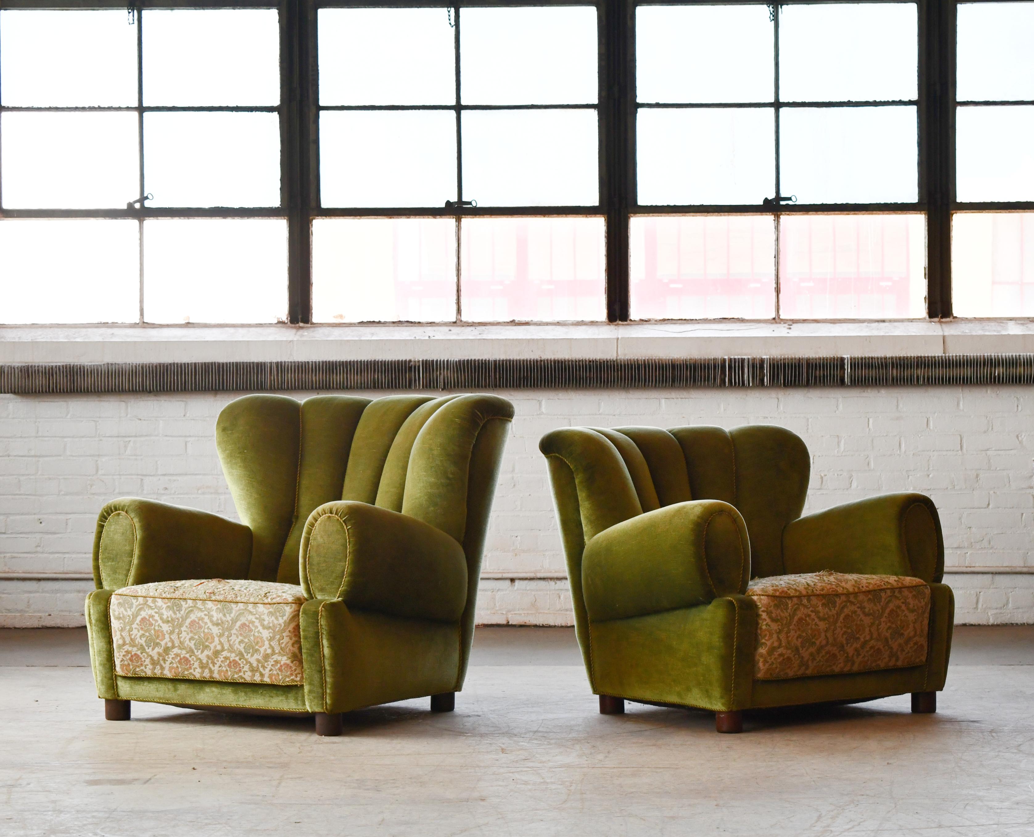 Pair of sublime large scale club chairs very similar to Fritz Hansen's famous model 1518 and likely made in the early 1940s. The chairs are unmarked and we are not aware of the Designer nor Maker. Raised on cylindrical legs. Superbly comfortable