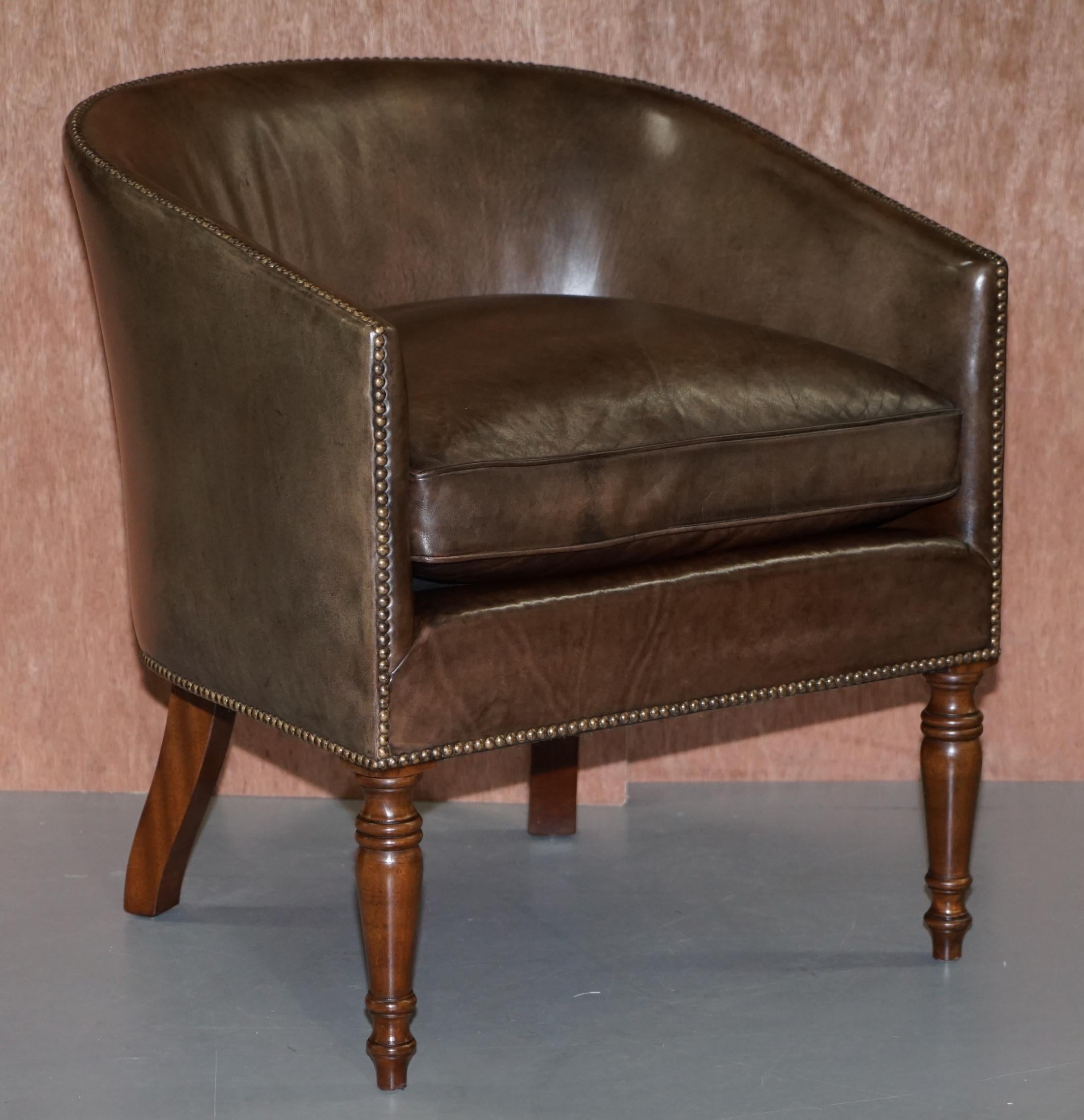 We are delighted to offer for sale this lovely pair of handmade in England brown leather barrel back tub armchairs 

A very well made pair, they have mahogany frames, the leather upholstery was fitted plain, hand antique studded in place then hand