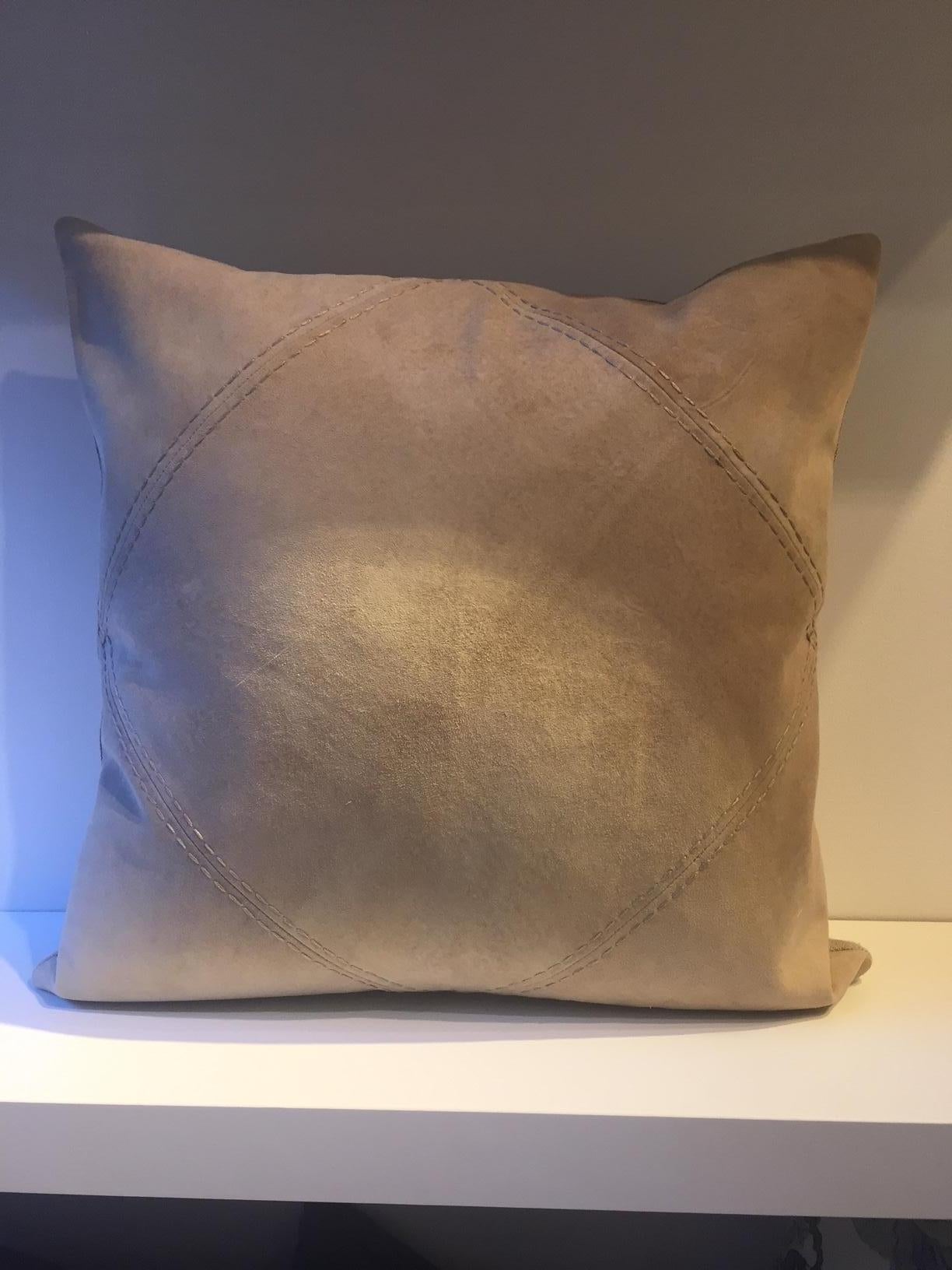 Pair of cushions, size: 50 x 50cm, front panel with Rhombus detail highlighted with hand saddle stitching in very soft suede leather color sand, back side panel in fabric, handwoven linen col. sand, cushion cover with cotton lining, concealed zip,
