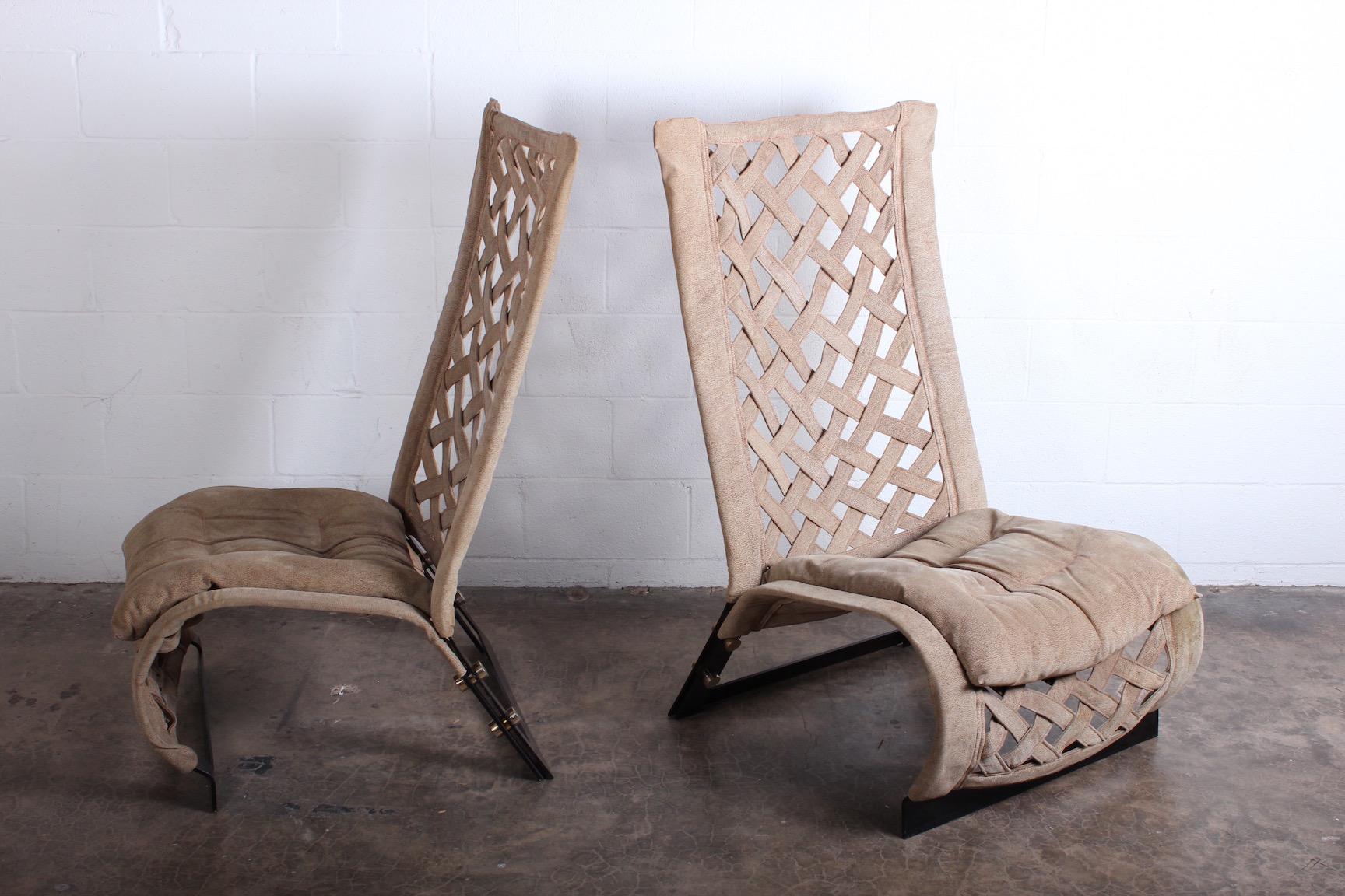 A pair of suede lounge chairs deigned by Mario Cecchi. Suede with enameled frames and brass hardware.