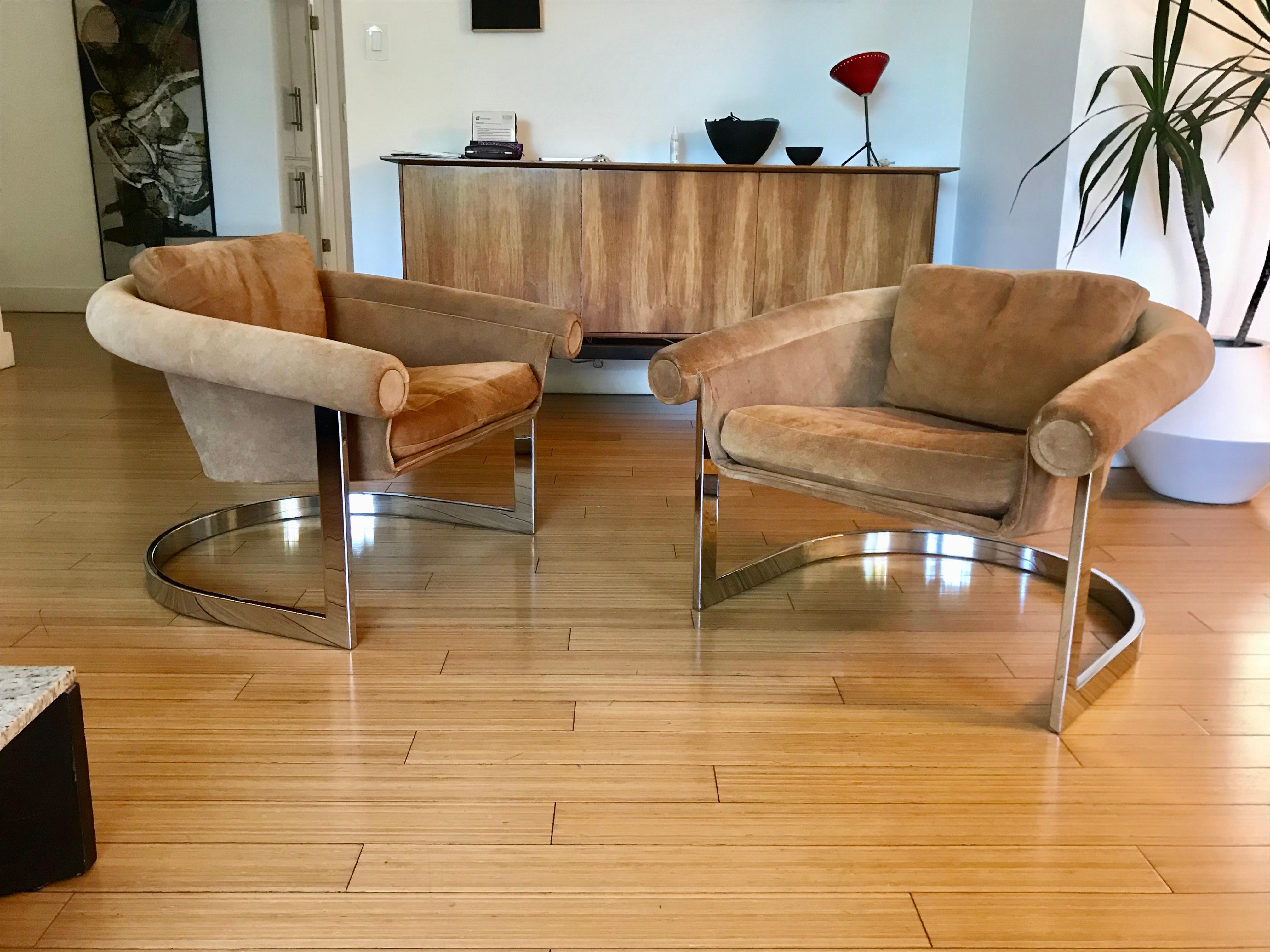 handsome pair of lounge chairs
original chestnut suede upholstery with chrome plated steel base
nice sling design floating on a cantilever base
original condition showing minor wear on the suede, a few surface stains, over-all good durable