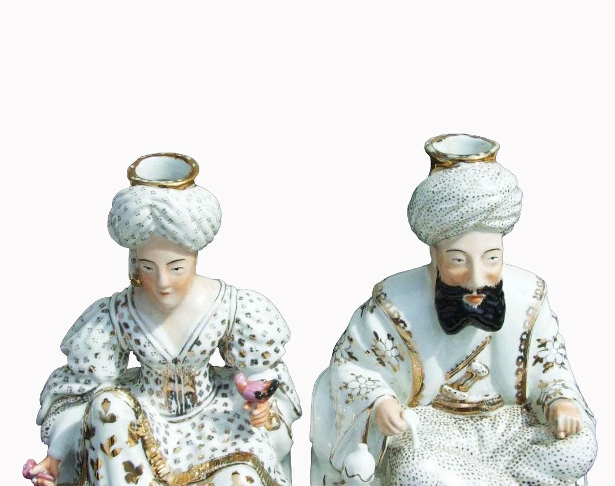 Pair of porcelain bottles made by Jacob Petit. The pair represents a couple dressed in an oriental way with fancy clothes and turbans. The sultan is smoking a pipe and the sultana is holding a bird. Each character is richly enhanced with gold and