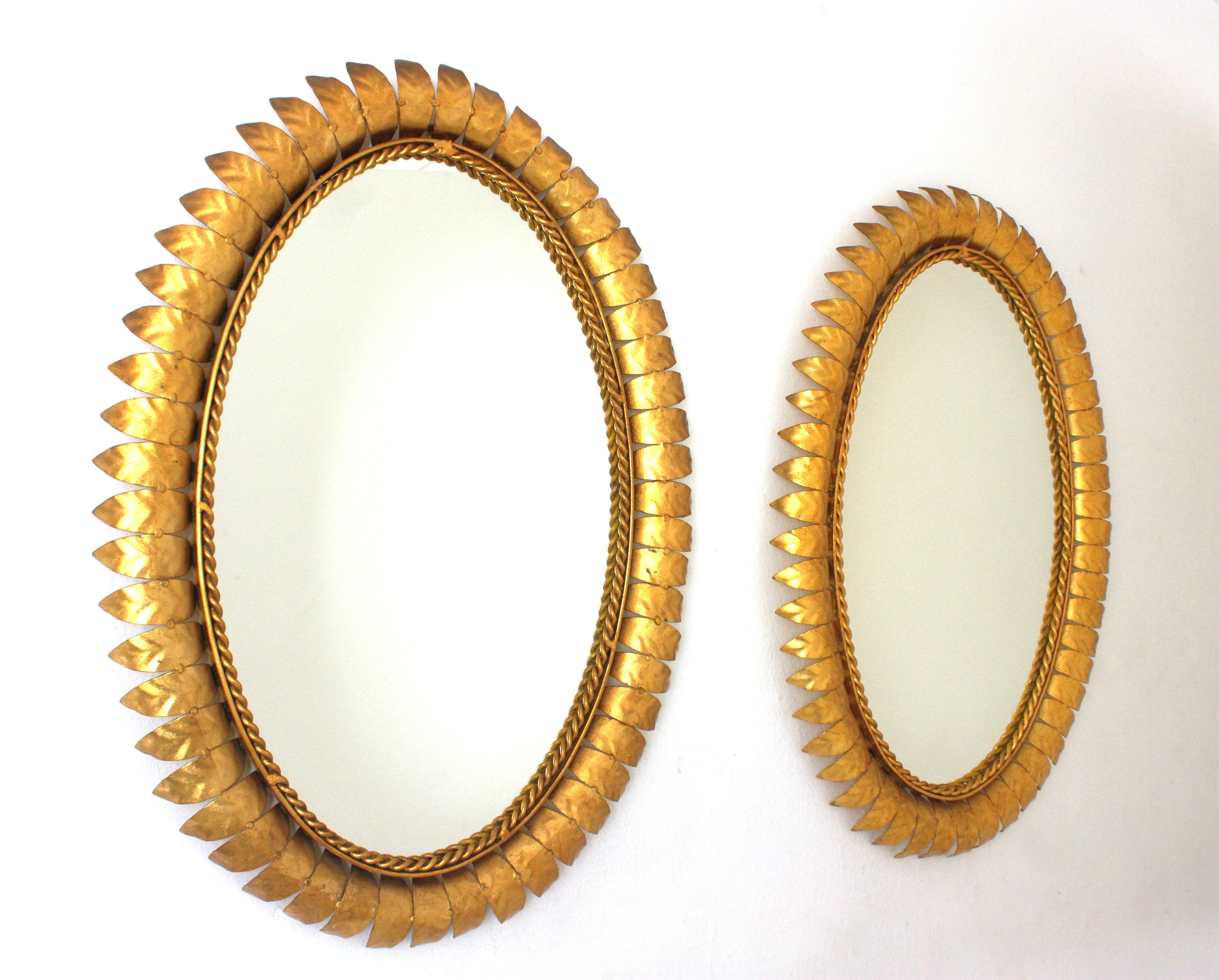 Mid-Century Modern Pair of Sunburst Oval Mirrors in Gilt Metal For Sale