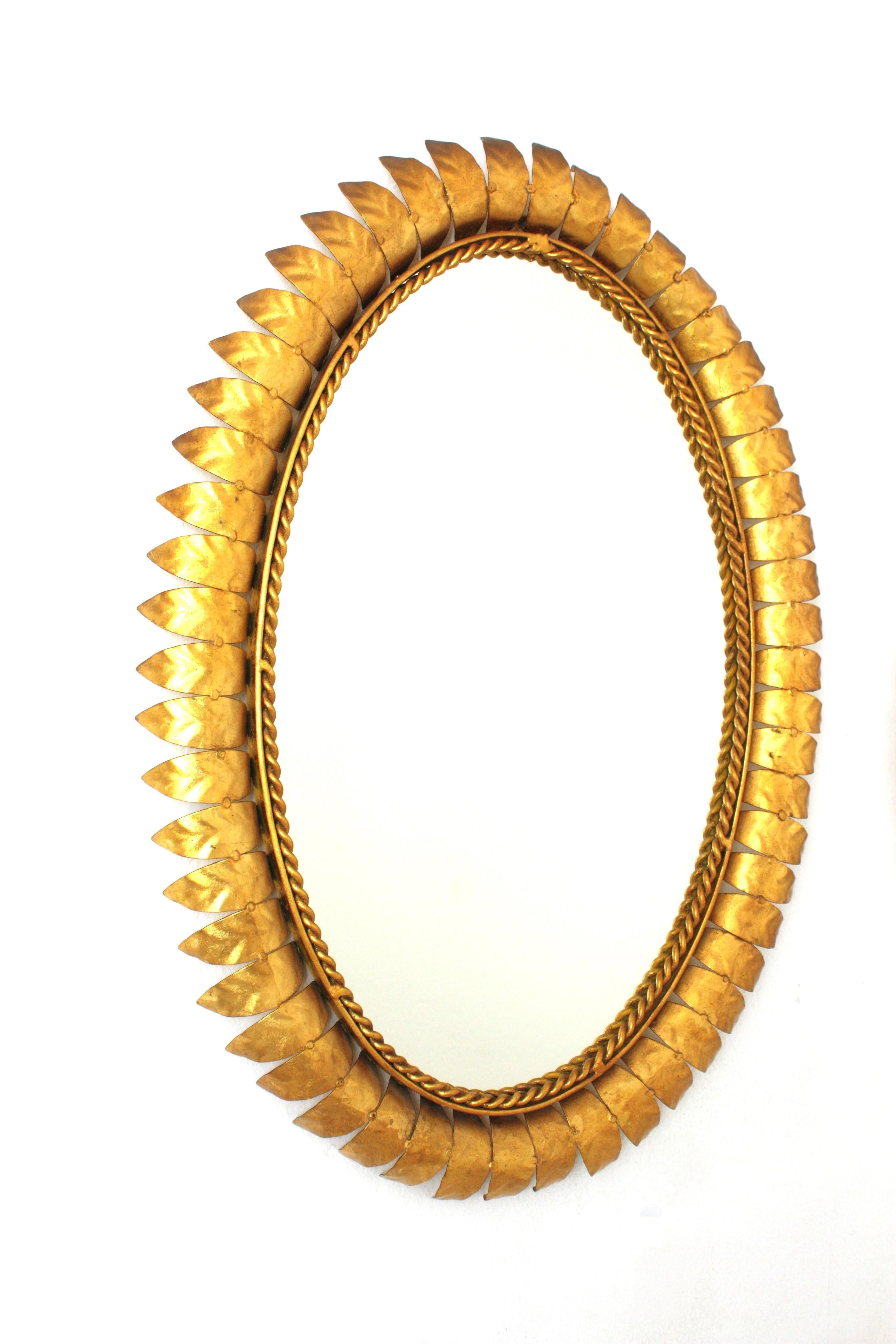 Spanish Pair of Sunburst Oval Mirrors in Gilt Metal For Sale