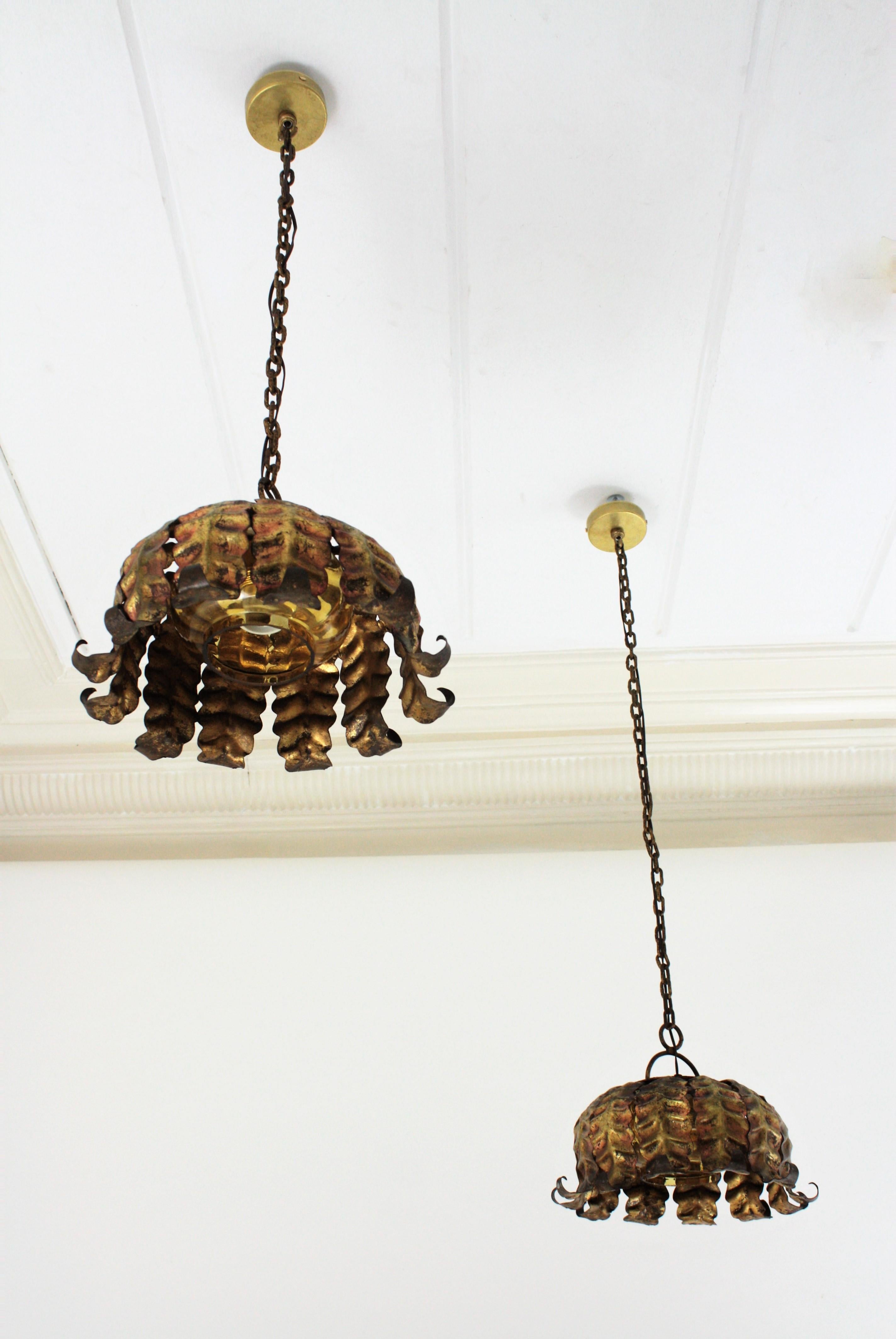 Pair of Spanish Sunburst Pendant Lights in Gilt Iron and Amber Glass For Sale 5