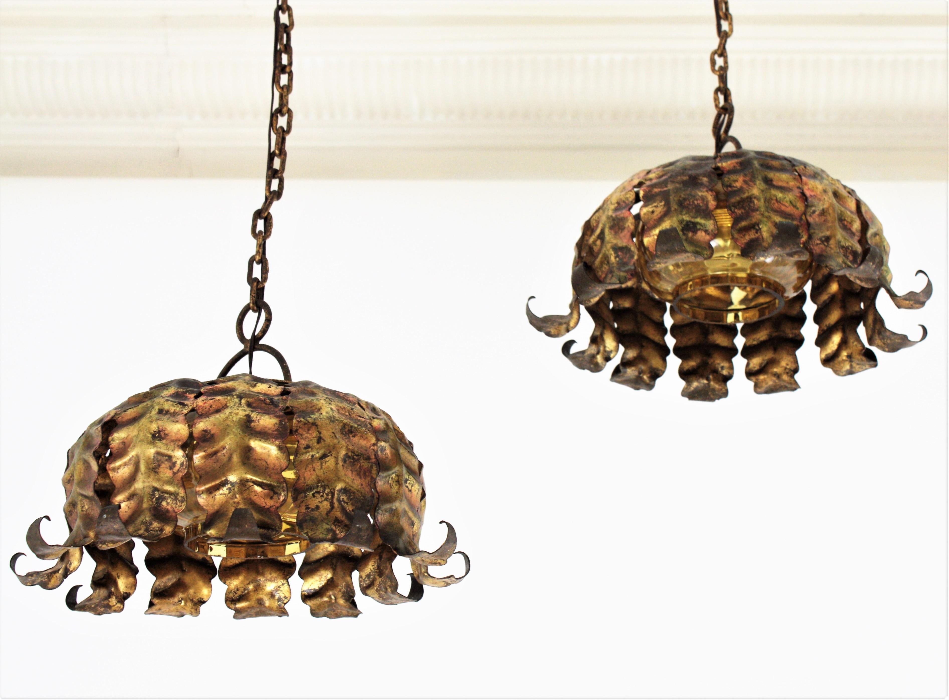 Mid-Century Modern Pair of Spanish Sunburst Pendant Lights in Gilt Iron and Amber Glass For Sale