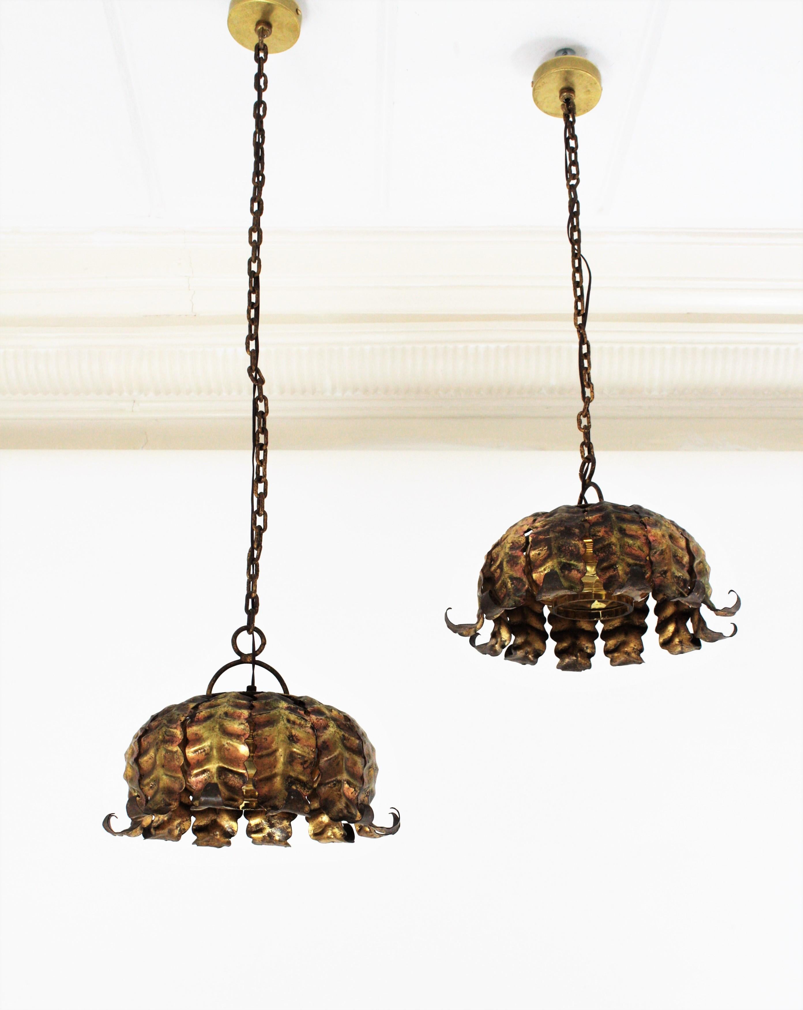 Metal Pair of Spanish Sunburst Pendant Lights in Gilt Iron and Amber Glass For Sale