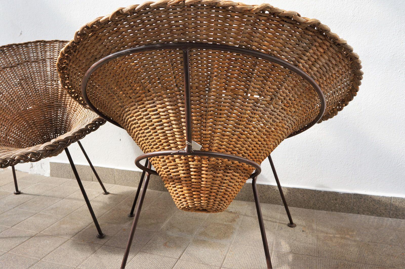 Large pair of sunflower-shaped rattan terrace chairs. The 4 leg base is polished iron rod and the saucer wicker sunflower is detachable for easy storage. Extremely comfortable & in excellent condition.