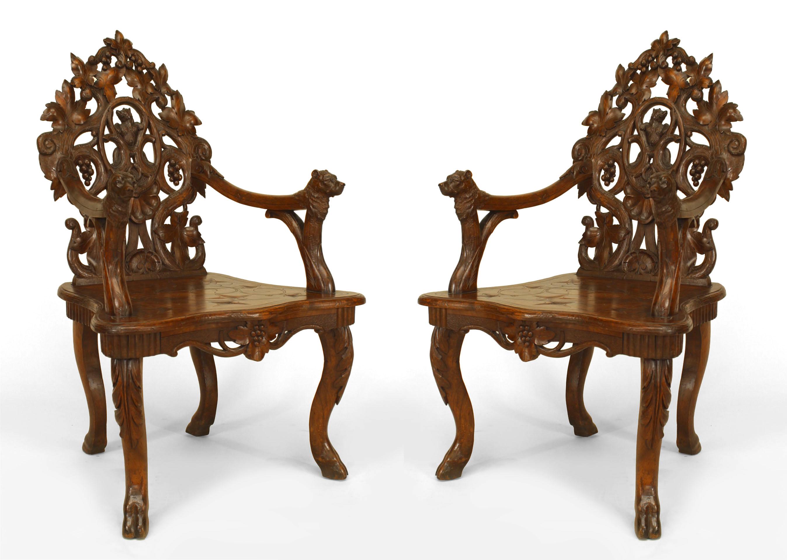 Pair of Rustic Black Forest (19th Cent) carved walnut open Armchairs with leaf and grape design filigree back and bear heads on arms with etched seat
