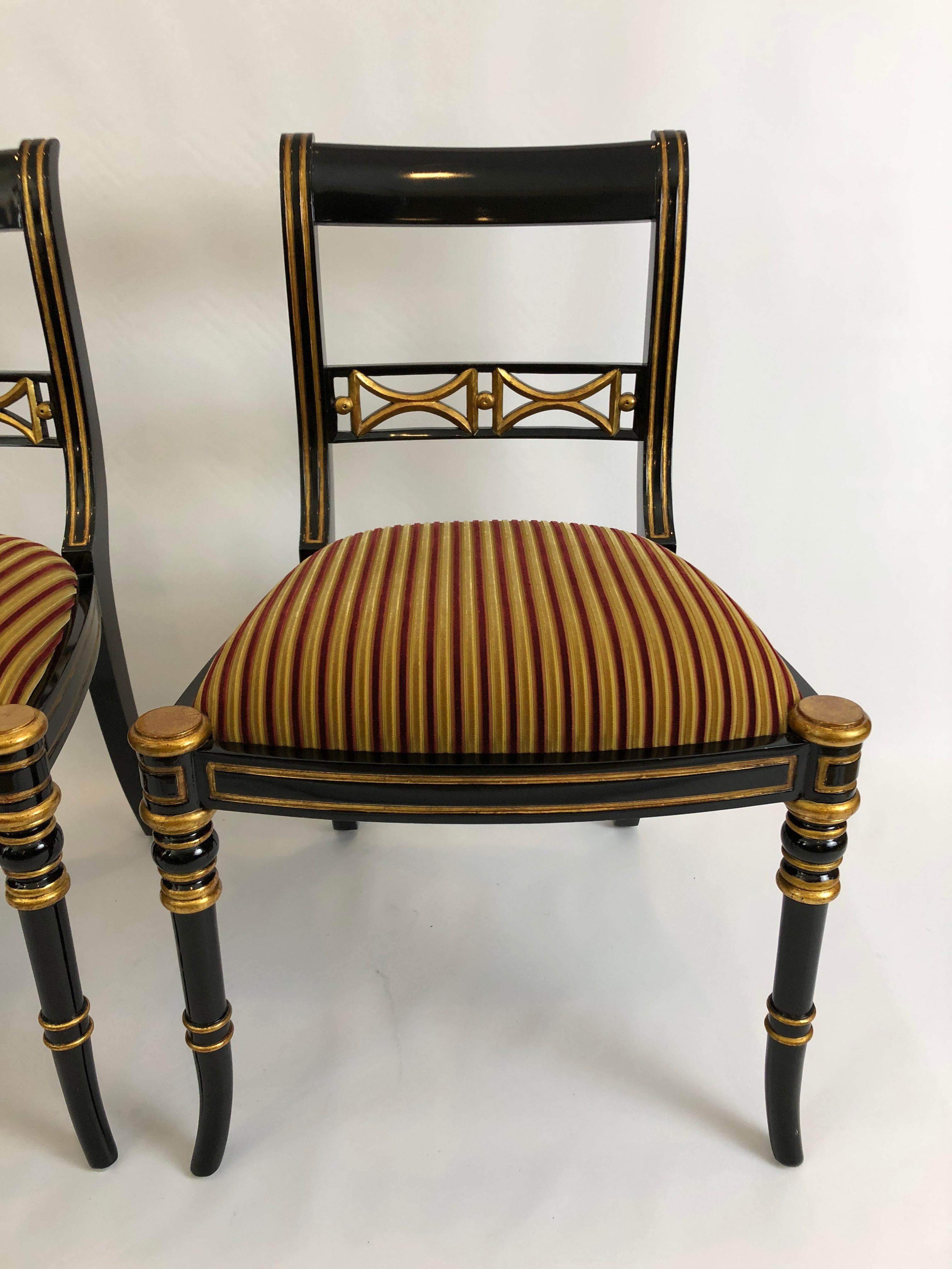 Two very elegant Regency style black and gold side chairs by Maitland Smith, having rich striped velvet seats. Great for a fancy living room or extra dining chairs.
Measures: Seat depth 18.