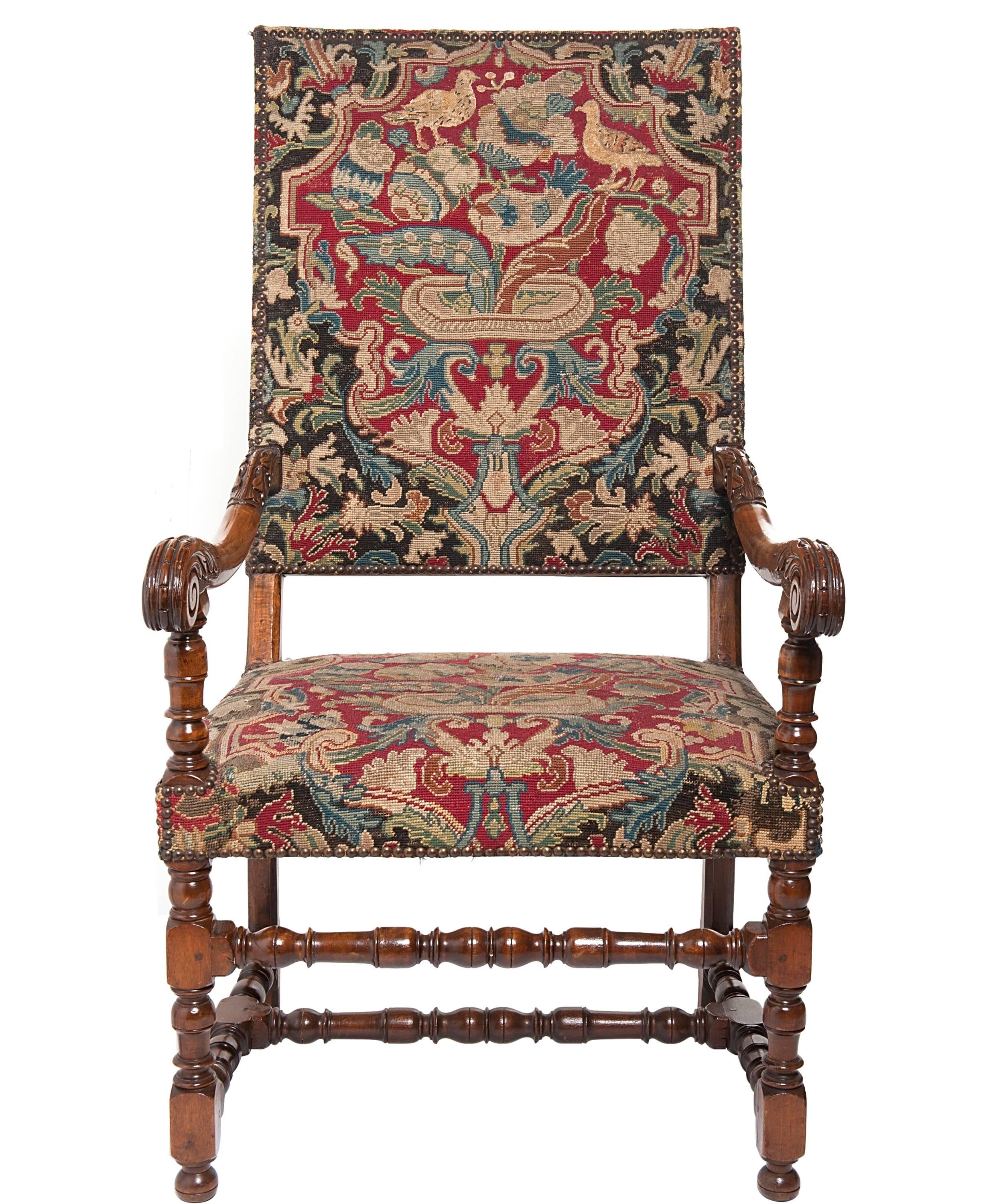 A superb of large walnut armchairs with slightly slanted rectangular backrests and cushioned seat. Scrolled and partly foliate carved arms finishing in 'bec de corbin'. On block and spooled turned legs linked by a stretcher. Both chairs upholstered