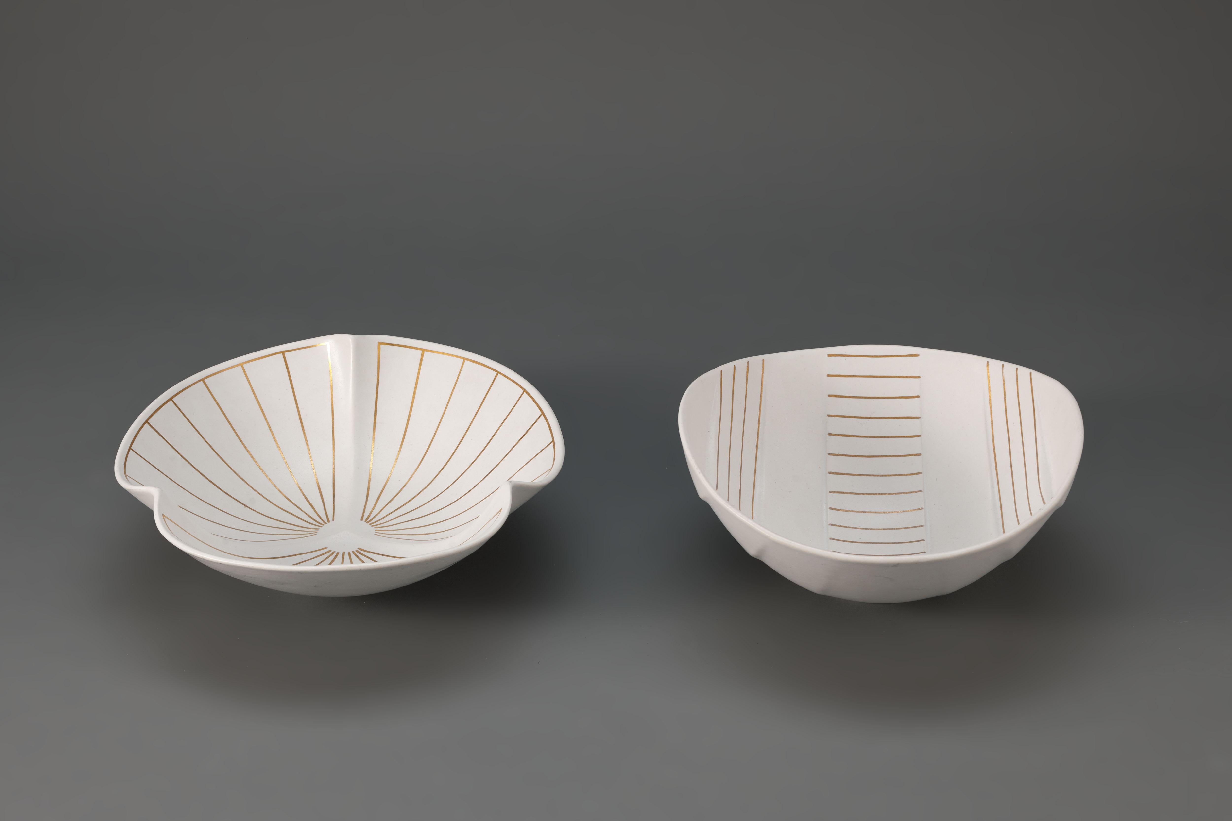 Pair of white Carrara glazed 'Surrea' (meaning 'surreal' in Swedish) bowls from the 'Guldsurrea' series by Wilhelm Kåge, designed in 1936. 

The Surreau series designs are characteristic because of their different counterbalance shape and therefore