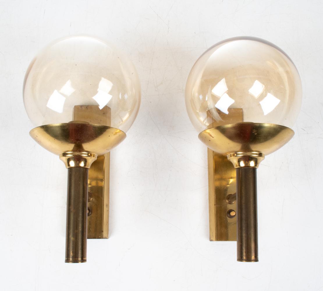 Step back in time and bask in the opulent glow of the 1960s with this exquisite pair of sconces by Svend Mejlstrøm for Mejlstrøm Belysning. An epitome of elegance, these fixtures encapsulate the soul of mid-century European design, harmonizing the