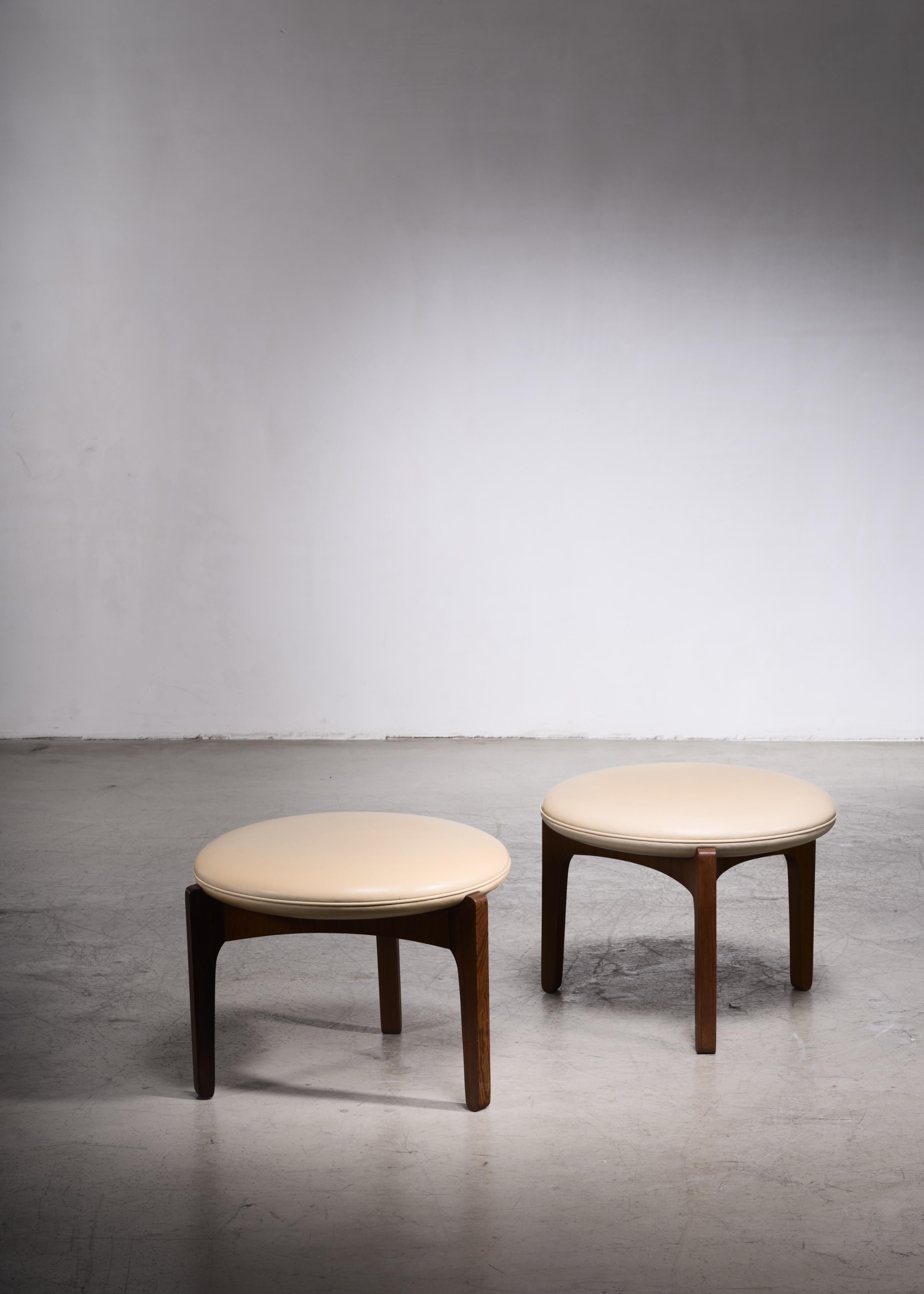 A pair of Danish 1960s tripod stools made of a rosewood frame with a leather cream colored cushion. Designed by Sven Ellekaer for Chr. Linneberg Møbelfabrik in 1962.

The stools have some minor wear, but are in an overall good condition. There are