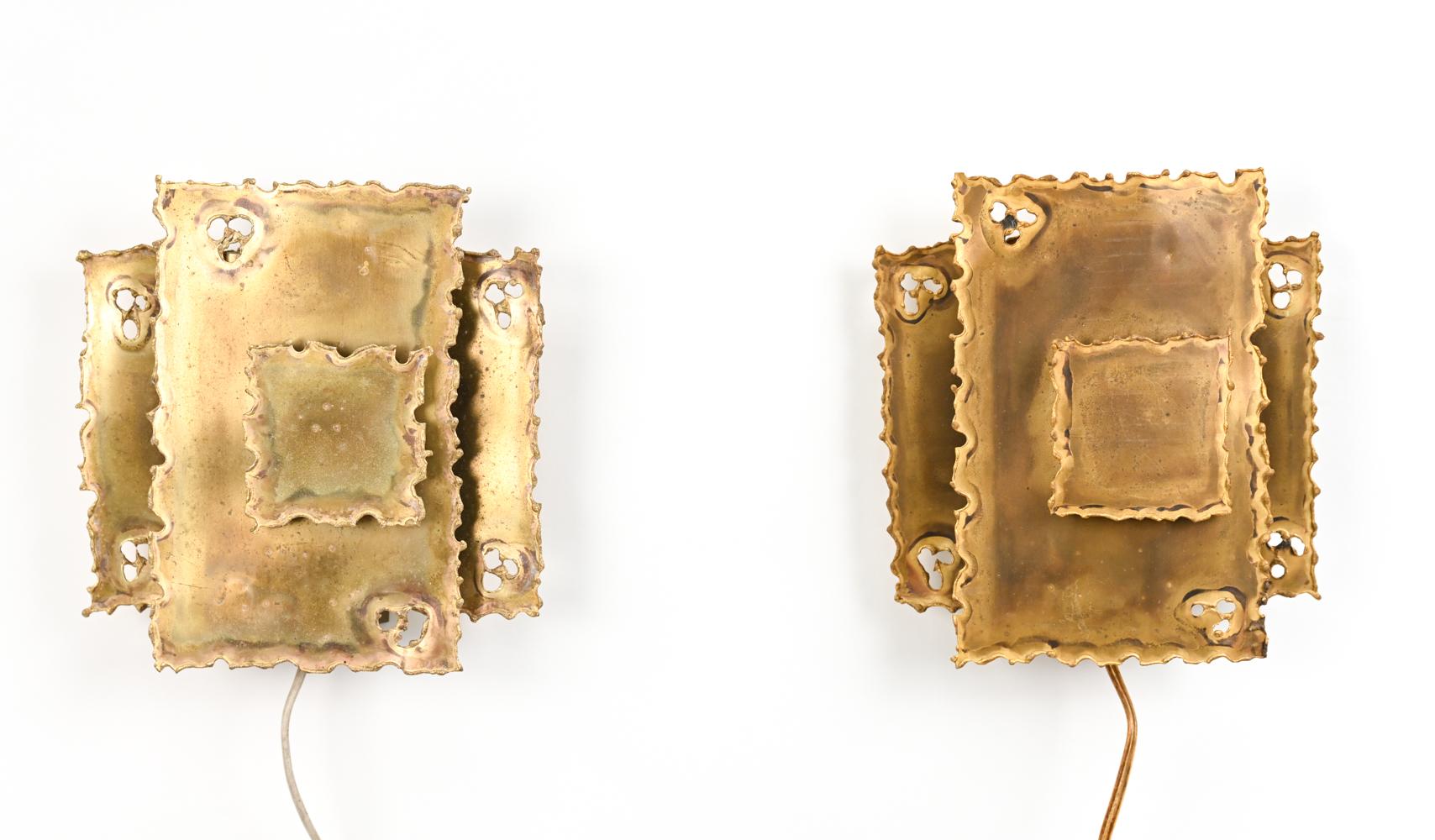 A fabulous pair of Scandinavian modern Brutalist wall sconces in torch-cut brass, designed by Sven Aage Holm Sorensen for Holm Sorensen Co., retaining original 