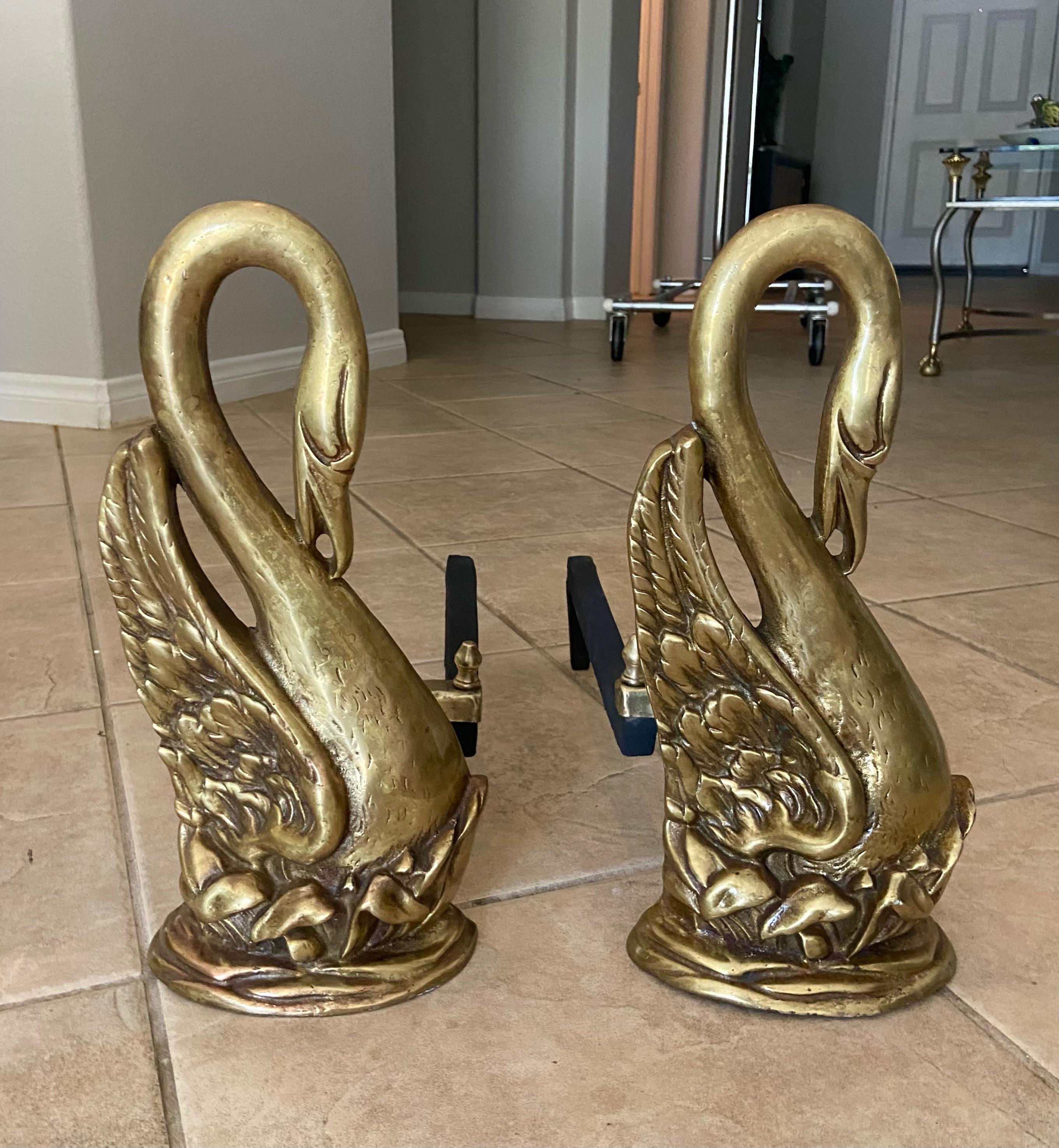 Pair of solid brass antique swan motif fireplace andirons. Very old with nice patina to brass.
