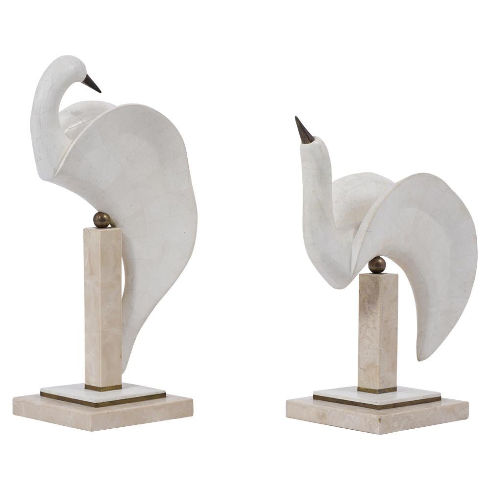 A pair of midcentury doves sculptures handcrafted out of soft stone veneers and are in great condition. This eye-catching standing swan figures rest on stable bases made from a marble and brass combination. These modern stone veneer herons would