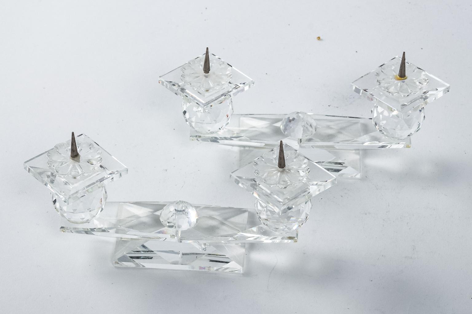 Pair of Swarovski crystal two-tier pin candleholders made during the second half of the 20th century. These candlesticks are in good condition with wear consistent with age. Made in Austria.