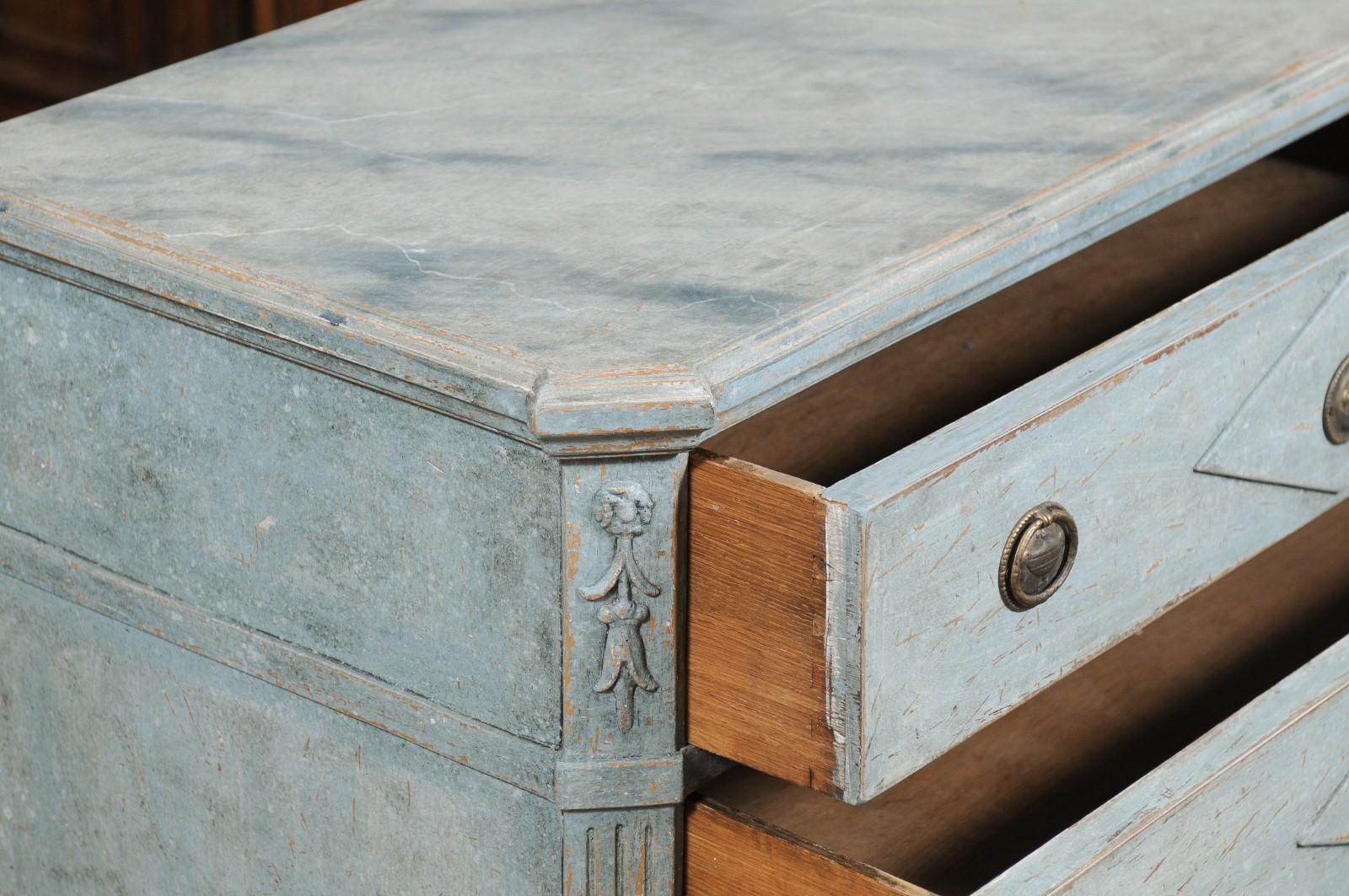 A pair of Swedish Gustavian style blue grey painted wood chests from the early 20th century, with marbleized tops and diamond motifs. Created in Sweden during the early years of the 20th century, each of this pair of painted chests features a