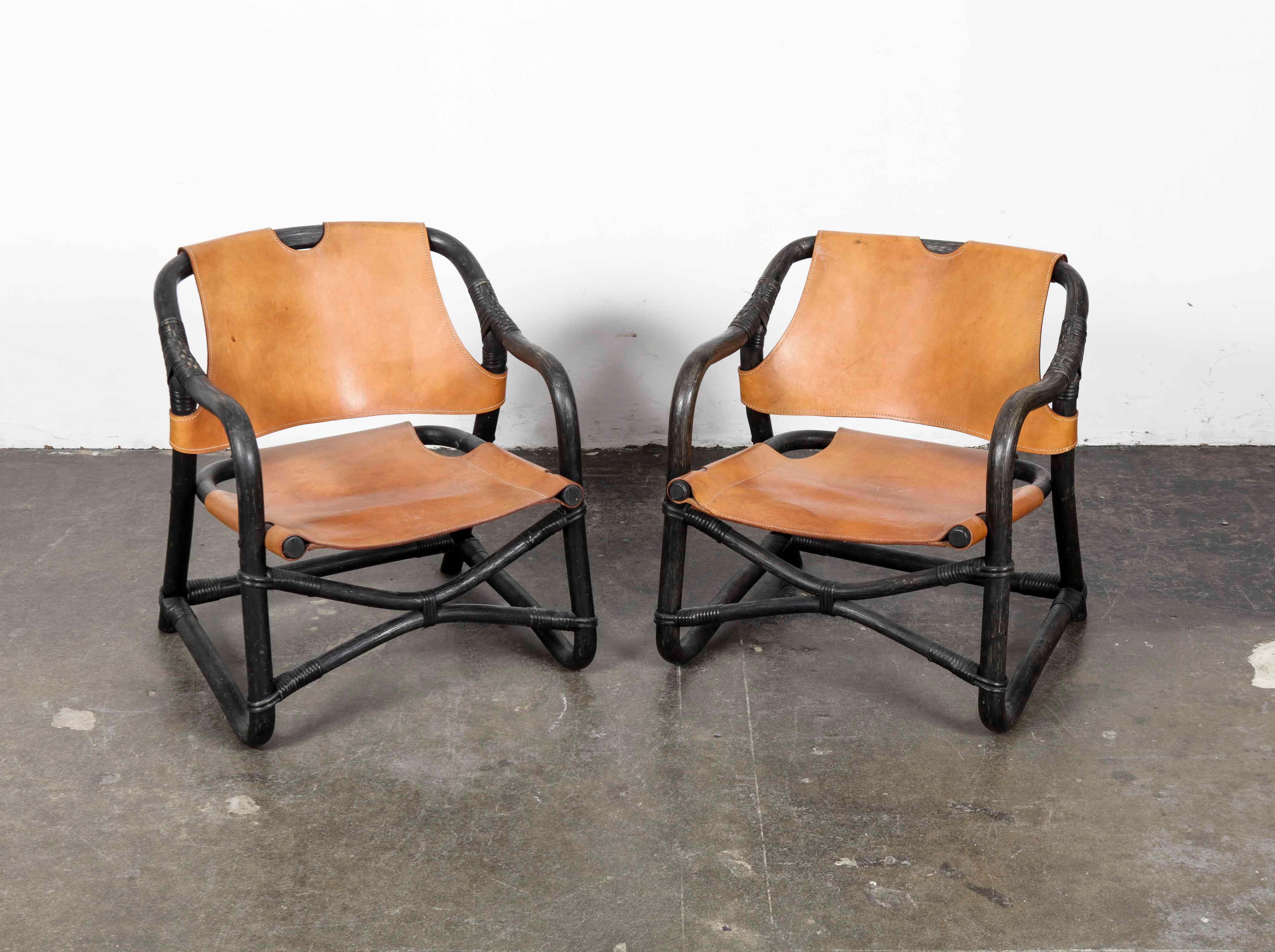 Pair of Swedish 1970s black lacquered bamboo framed chairs with original saddle colored leather sling seats and backs. Possibly vintage Ikea. Small profile chairs with a lower seat.