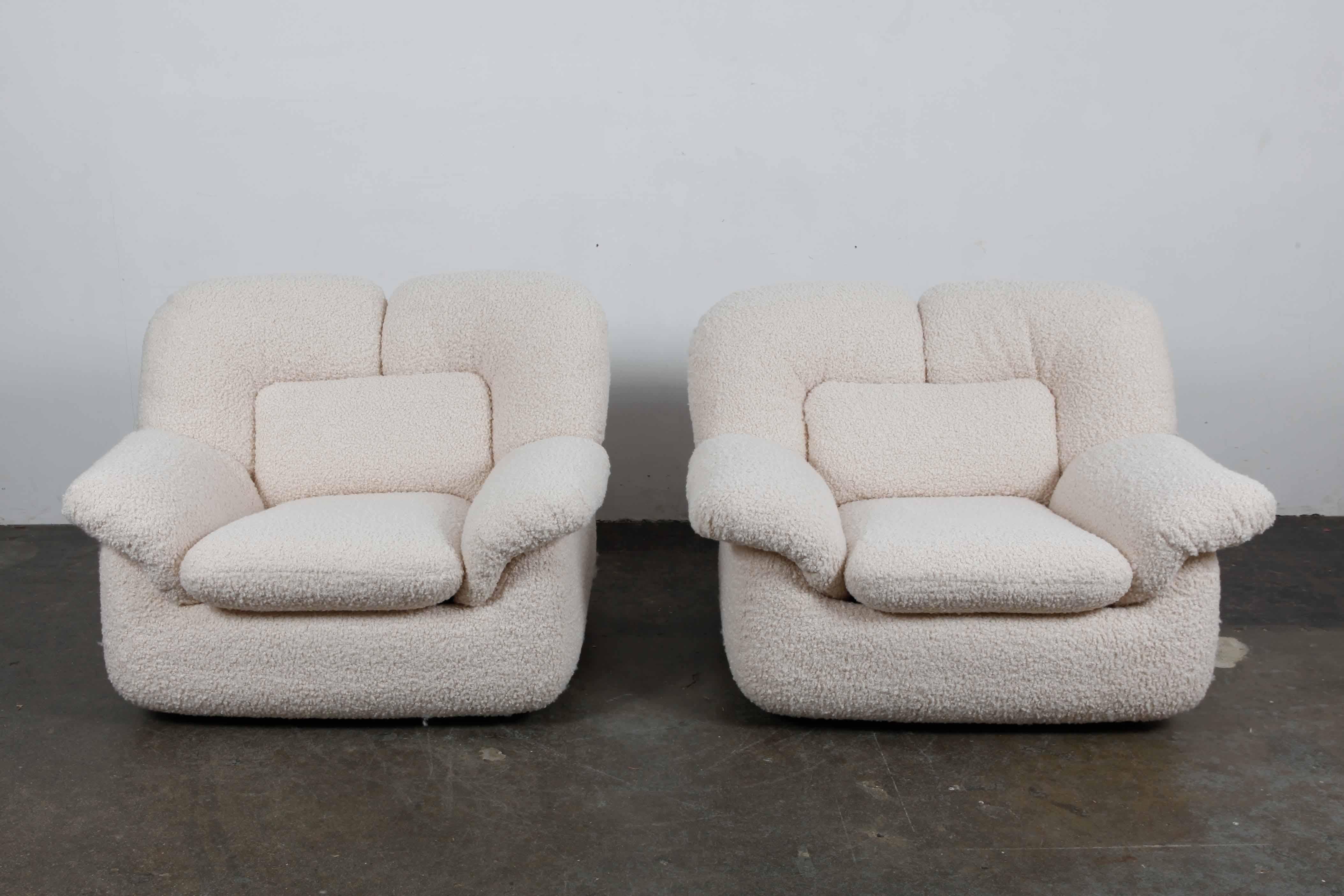 Pair of wide, low lounge chairs from the 1970s, Swedish but in a very Italian style. Newly upholstered in an off white boucle fabric.