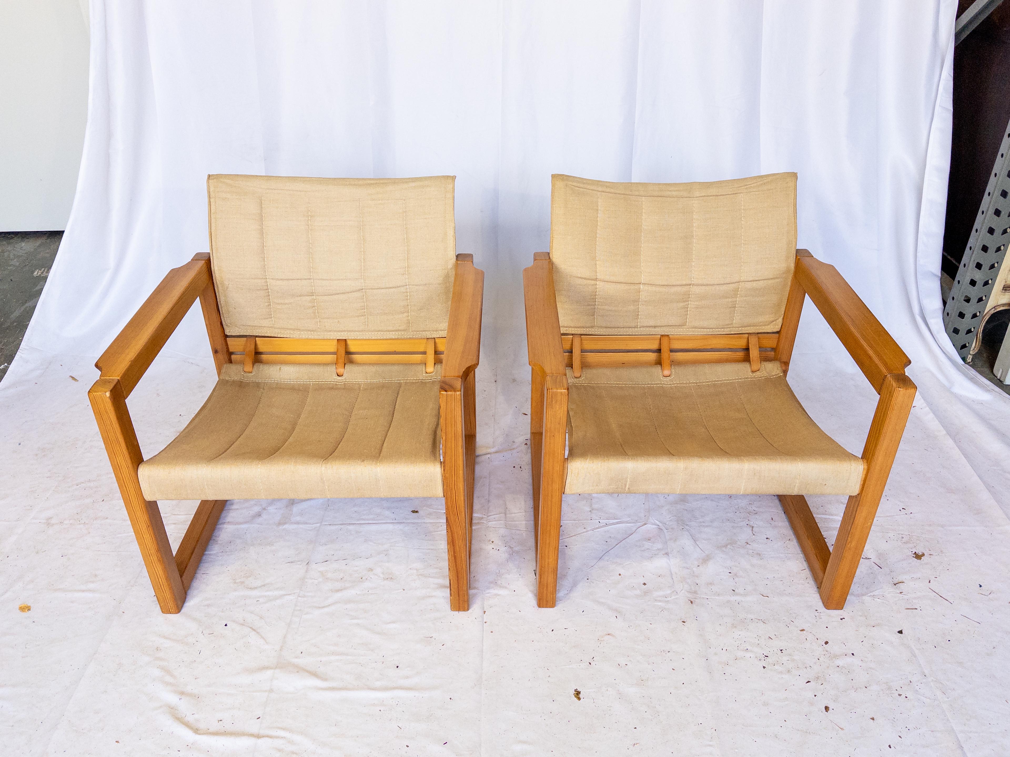 The Swedish 1970's Safari Armchairs by Karin Mobring exude a timeless charm and rugged elegance. Crafted with solid pine wood frames, these armchairs boast durability and a natural aesthetic. The canvas upholstery adds a touch of comfort while