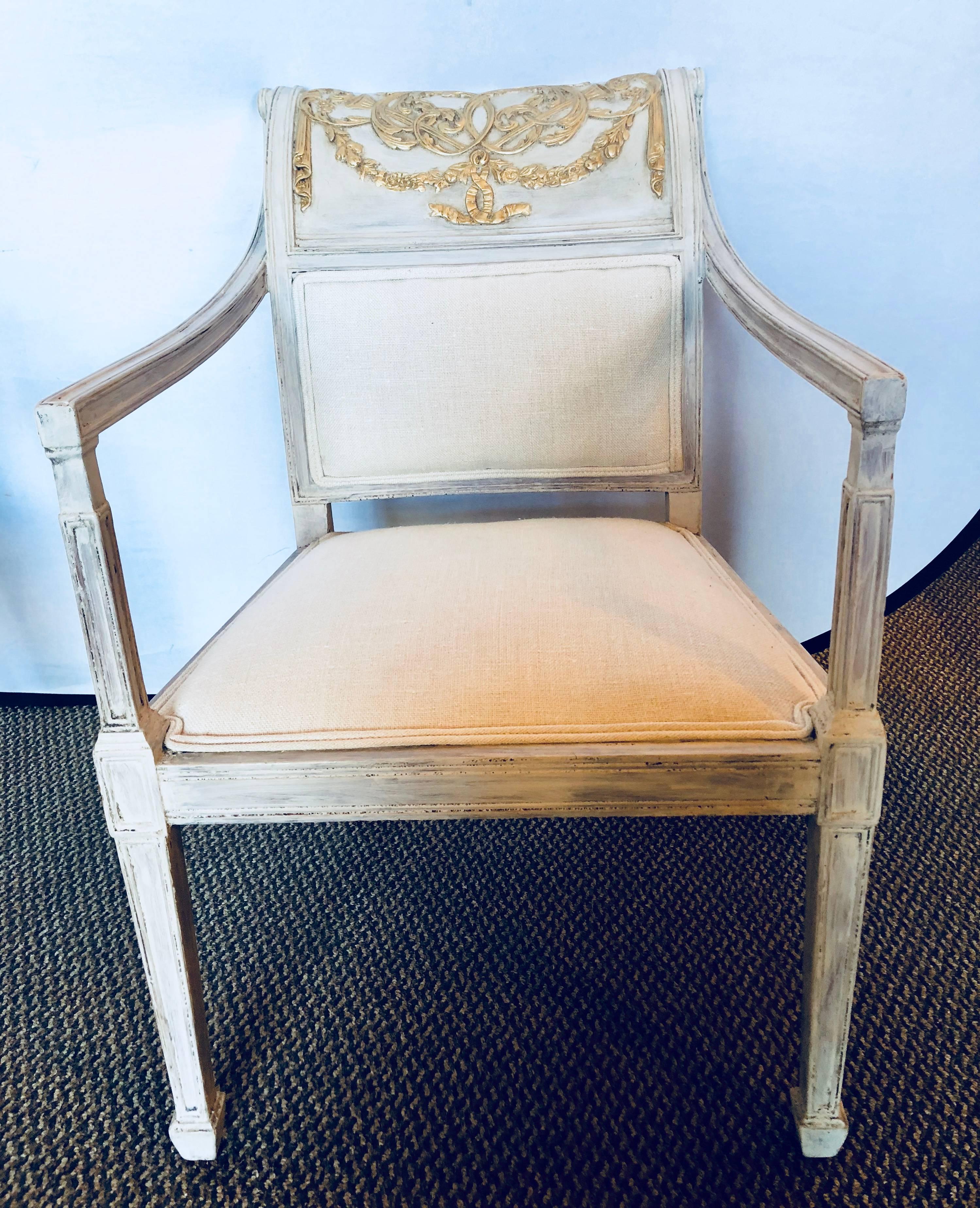 Pair of Swedish and parcel-gilt decorated armchairs in new fabric. These fine vintage Swedish armchairs have a wonderful finish with a finely carved and gilt decorated backrest. The carving of trumpet and tassel with ribbon form.
 