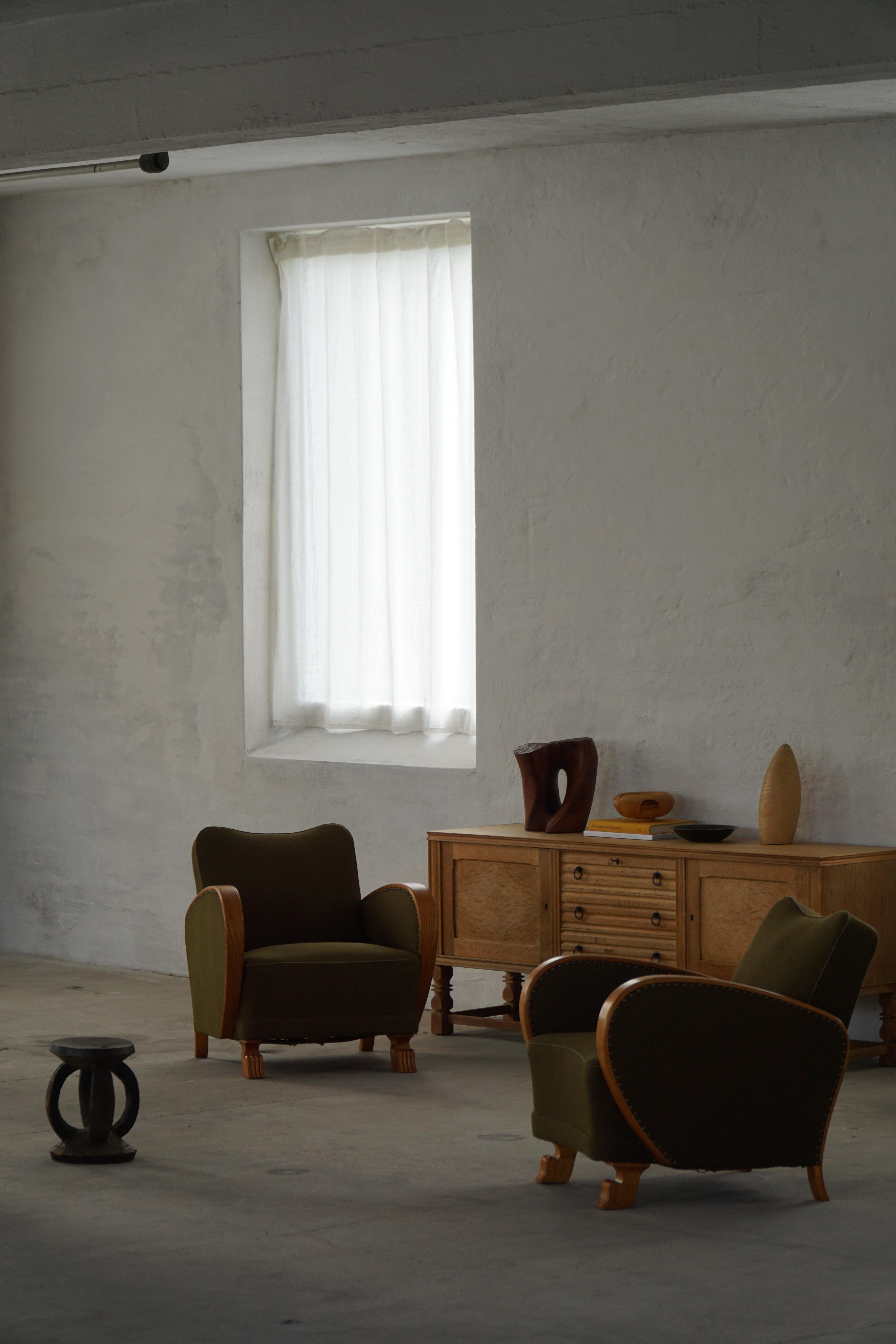 A beautiful pair of Swedish Modern armchairs / lounge chairs from the 1930s–1940s, combining the restrained elegance of Scandinavian design with the refined sculptural detail of Art Deco craftsmanship. Executed in solid elm, the chairs feature