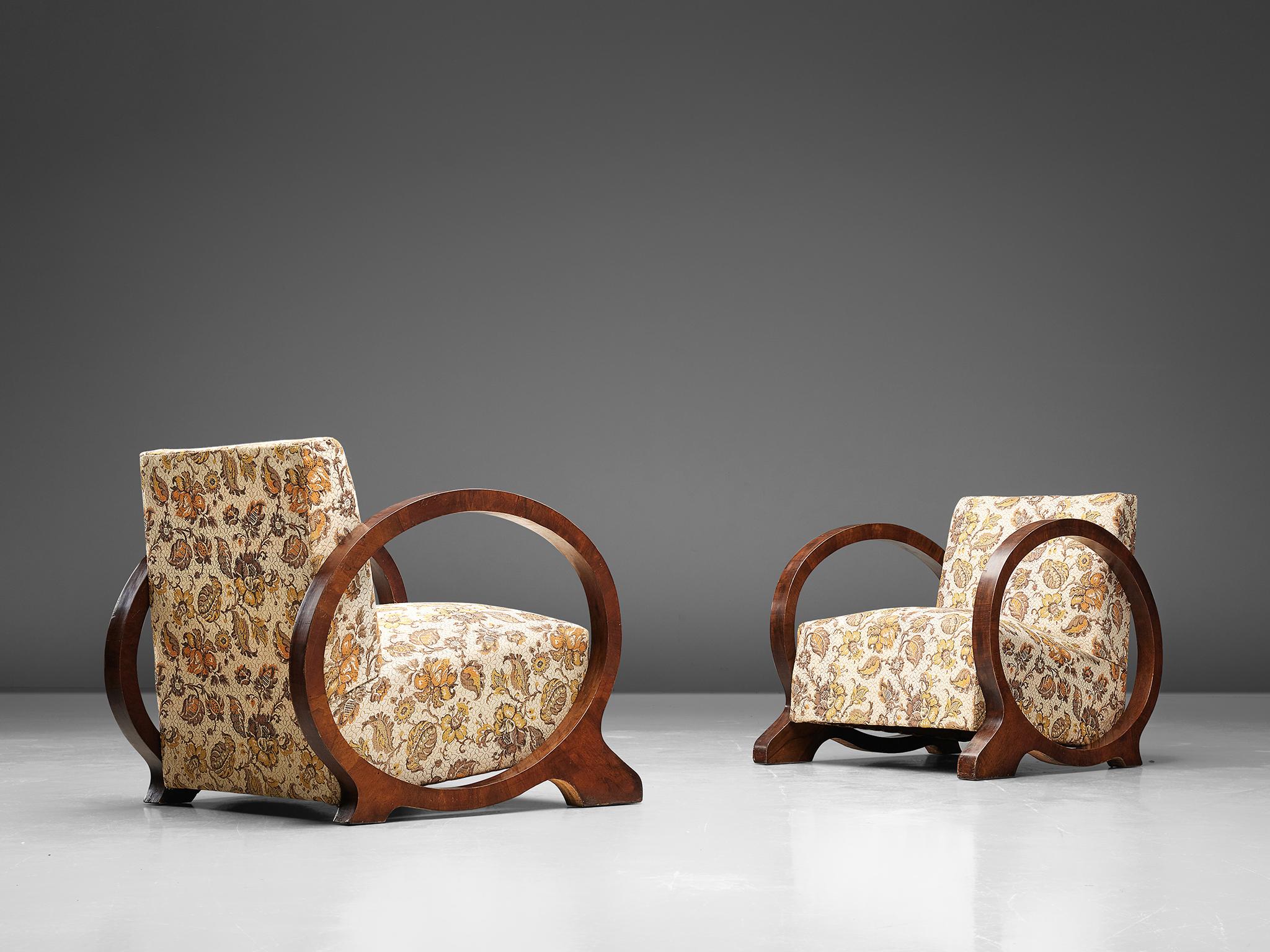 Set of armchairs, walnut and fabric, Sweden 1930s. 

Pair of extraordinarily designed Swedish armchairs. The armrests the legs and the base of the chair are all created out of one circle. This round form on each side or the chair is executed in