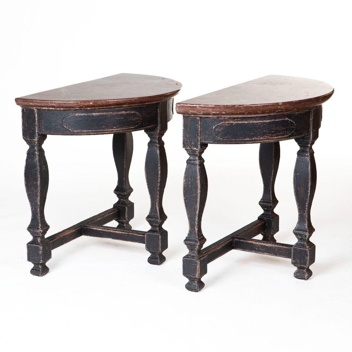 Pair of architectural and decorative console tables in Baroque style.
Black-painted base with baluster-shaped legs, joined by a cross stretcher.
Elegant demi-lune tops in Öland stone, a warm reddish-brown hue with striking lighter veining.
Executed