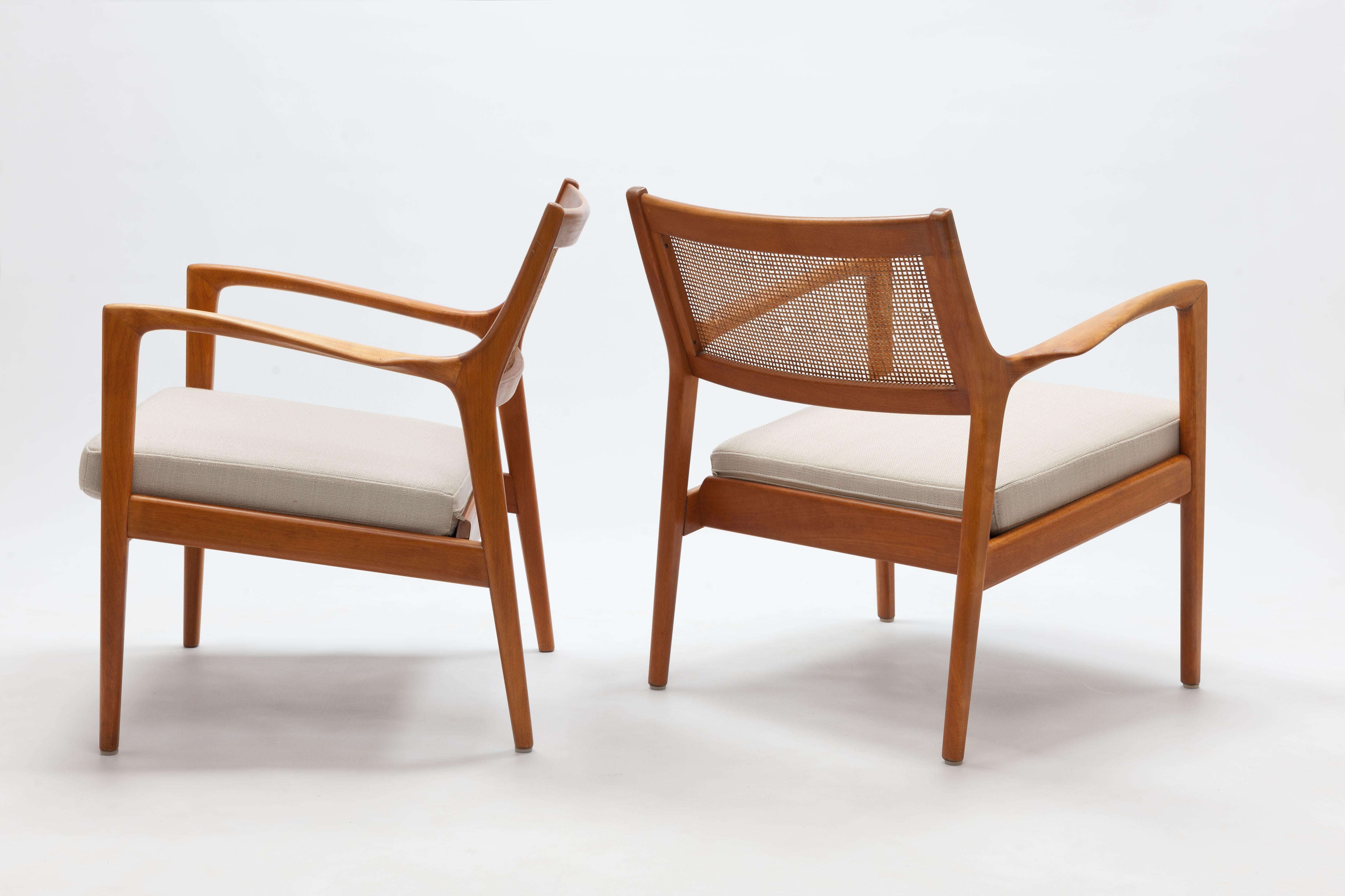 Pair of Karl Erik Ekselius lounge chairs by JOC Møbler Sweden 1960. 
Frames of solid honey stained beech with back rests of woven cane and new loose cushions. 
Beautiful lounge chairs with elegant lines and great comfort.

