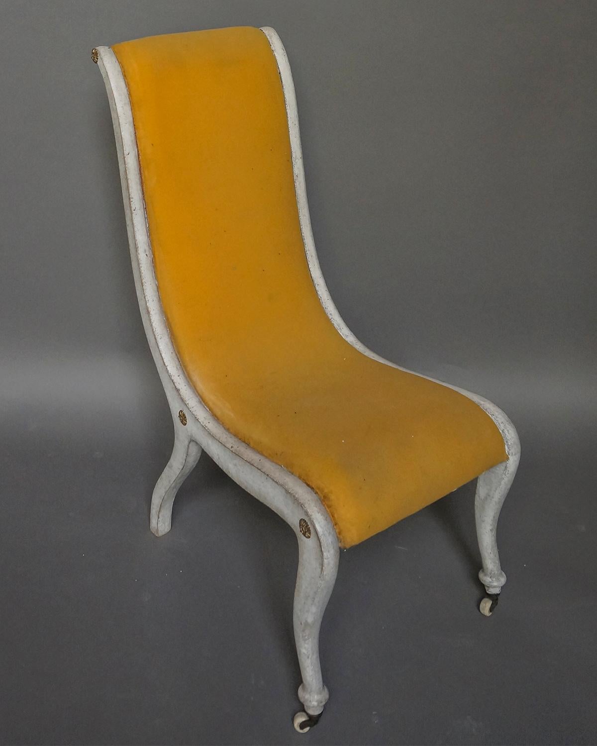 An unusual pair of Biedermeier slipper chairs, Sweden circa 1830, with curved form and original brass fittings. Extremely comfortable.
