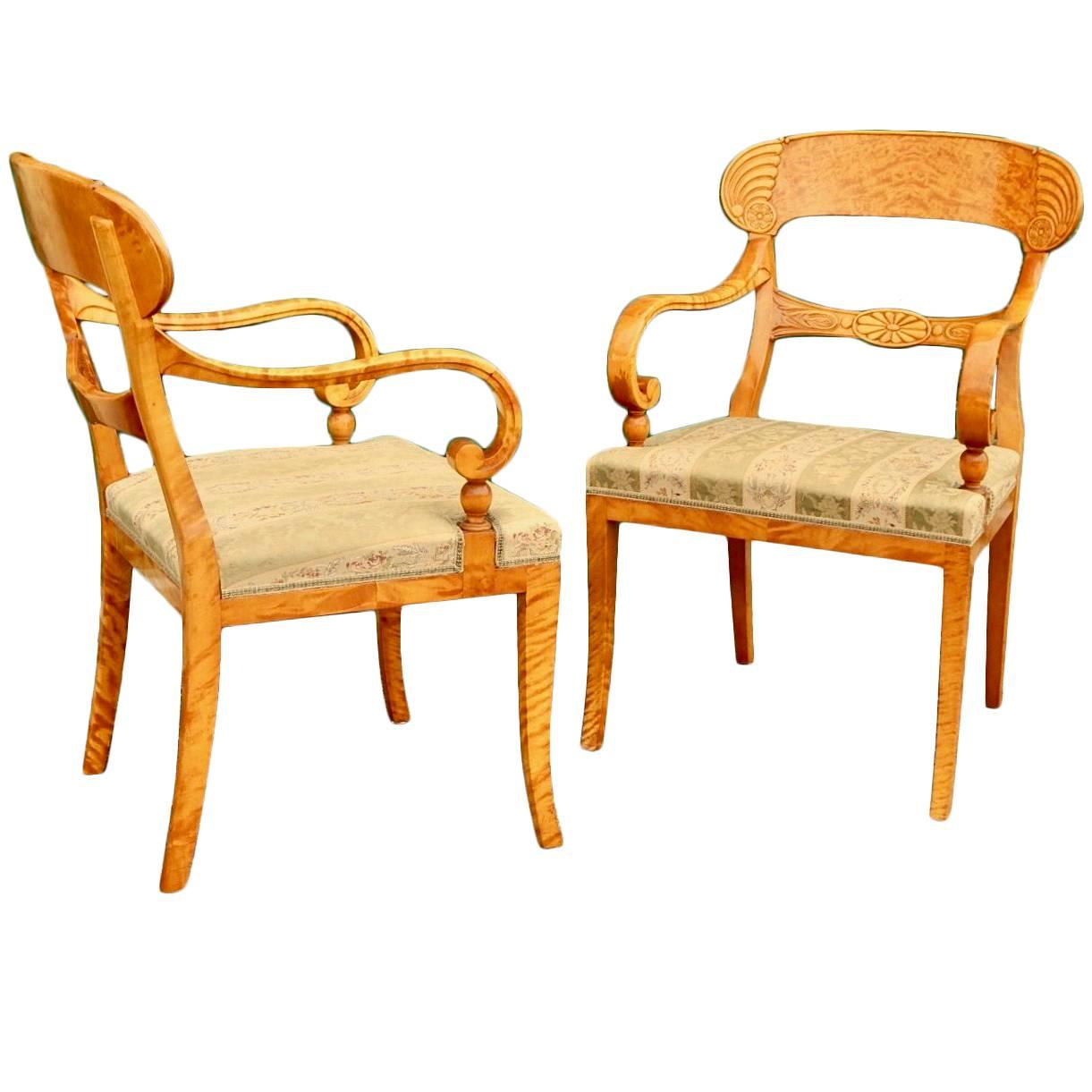 Pair of Swedish Biedermeier Revival Captains chairs in golden flame birch 1920s pair of Swedish Biedermeier Revival captain's chairs rendered in highly figured golden flame birch wood. Wood inn excellent original condition. With original very worn