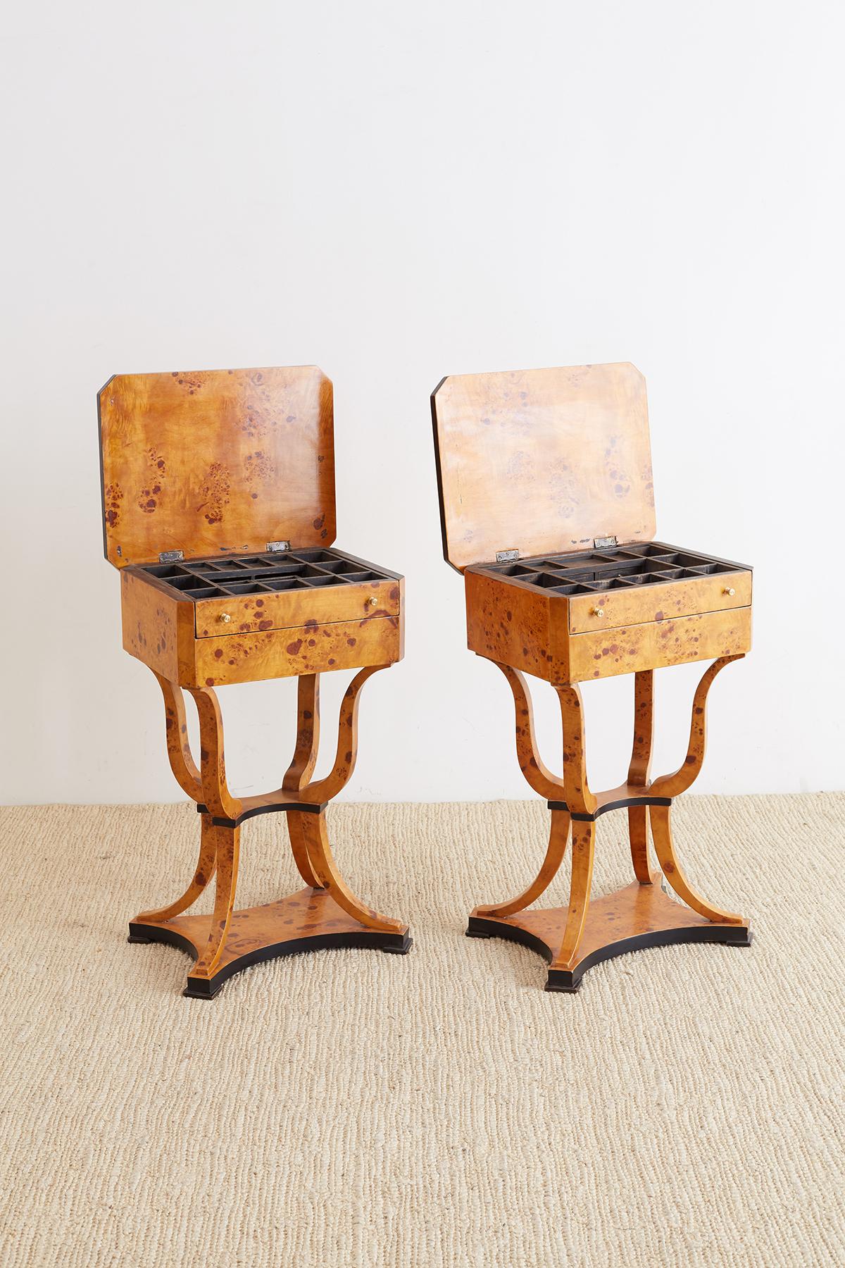 Elegant pair of Swedish sewing tables made in the Biedermeier style of birch and maple burl wood. Distinctive flip top style opens to a removable fitted drawer. The case has beveled edges and a drawer on the side. Beautifully constructed from burl